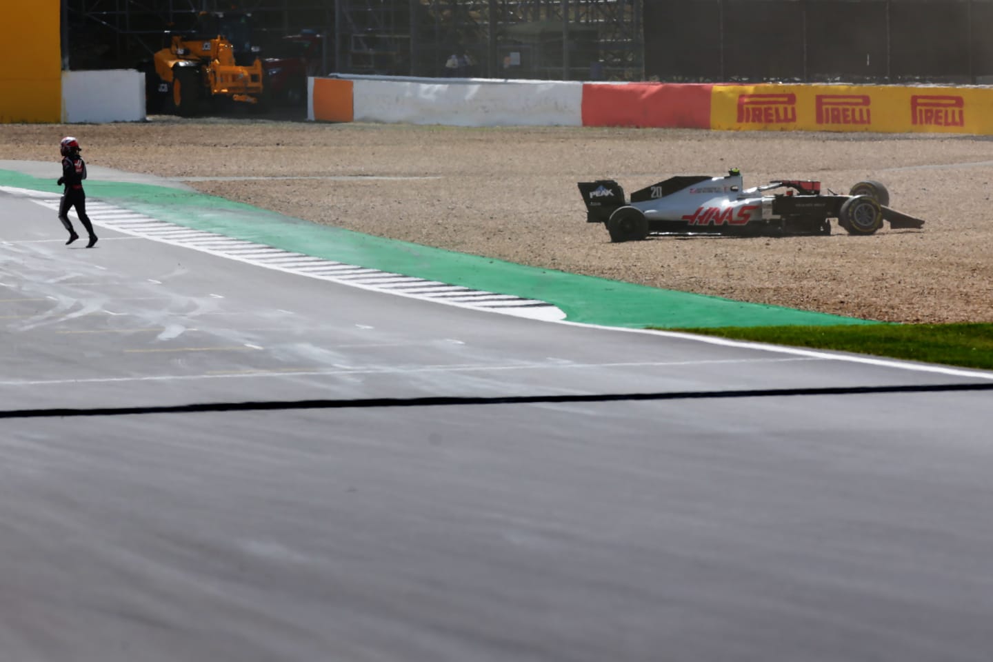 NORTHAMPTON, ENGLAND - AUGUST 02:Kevin Magnussen of Denmark and Haas F1 runs from his car after spinning off during the F1 Grand Prix of Great Britain at Silverstone on August 02, 2020 in Northampton, England. (Photo by Peter Fox/Getty Images)