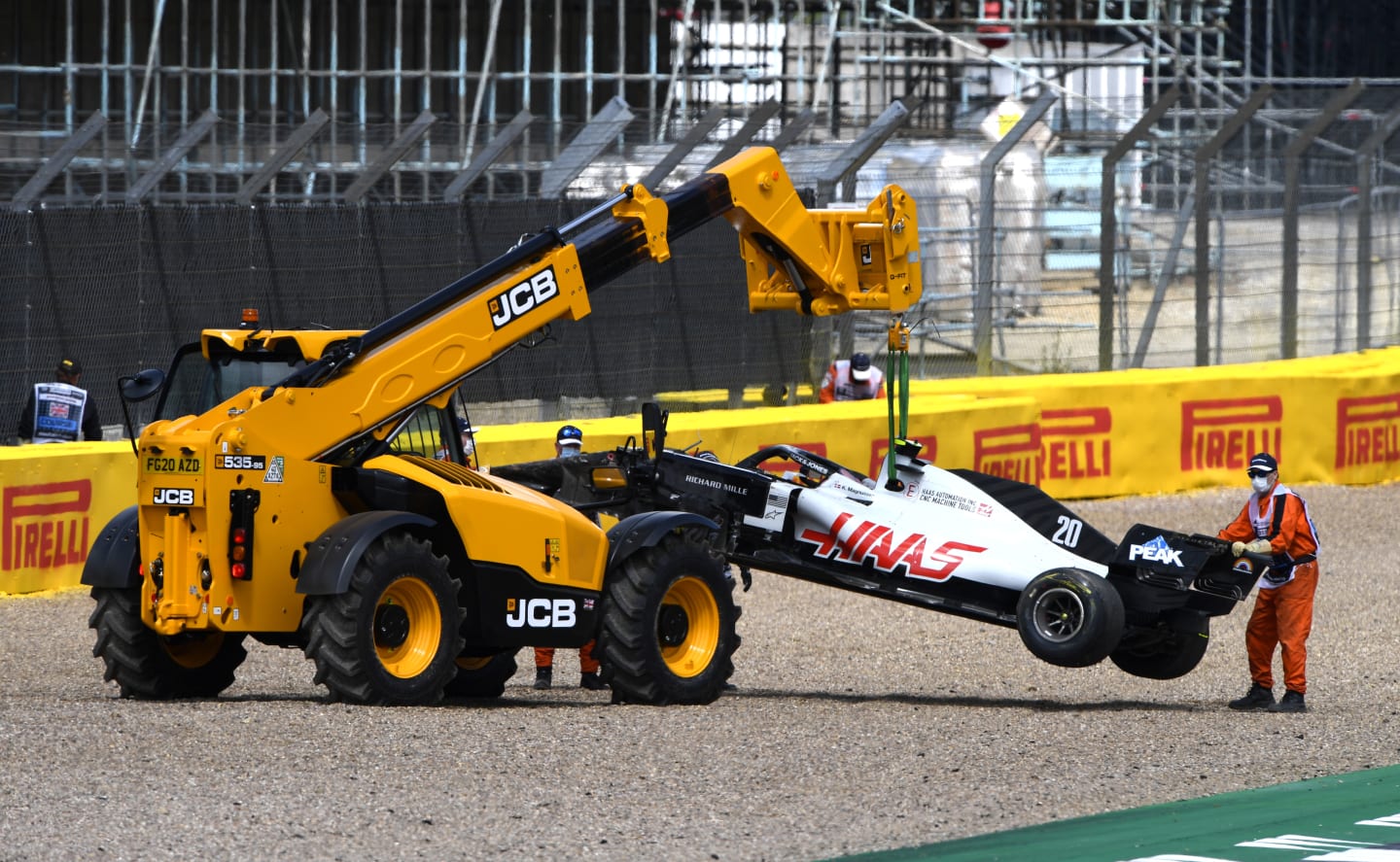 NORTHAMPTON, ENGLAND - AUGUST 02: The car of Kevin Magnussen of Denmark and Haas F1 is taken away