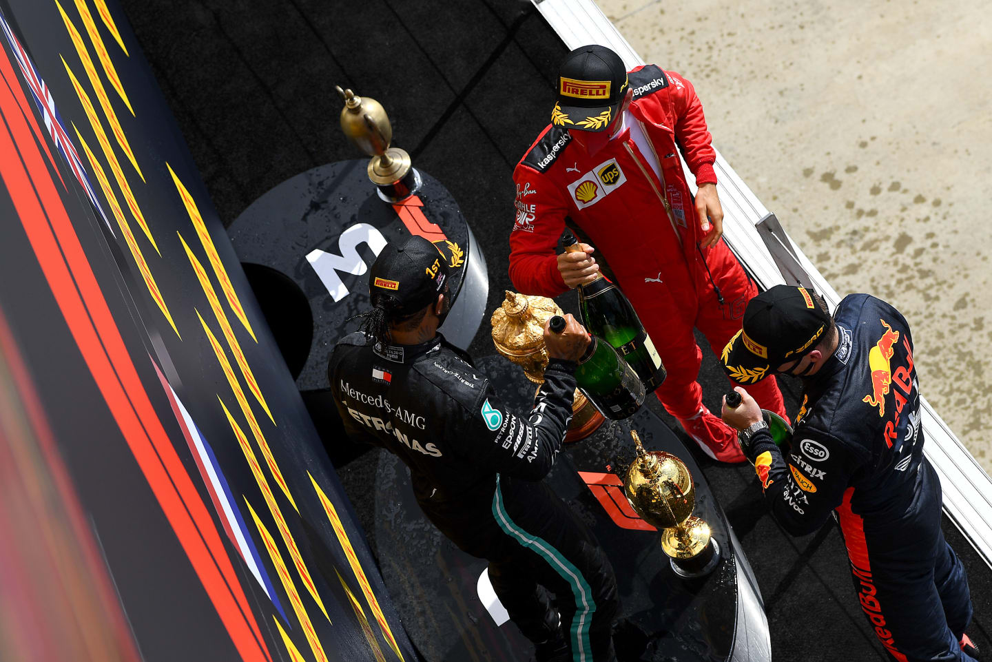 NORTHAMPTON, ENGLAND - AUGUST 02: Race winner Lewis Hamilton of Great Britain and Mercedes GP, second placed Max Verstappen of Netherlands and Red Bull Racing and third placed Charles Leclerc of Monaco and Ferrari celebrate on the podium during the F1 Grand Prix of Great Britain at Silverstone on August 02, 2020 in Northampton, England. (Photo by Clive Mason - Formula 1/Formula 1 via Getty Images)