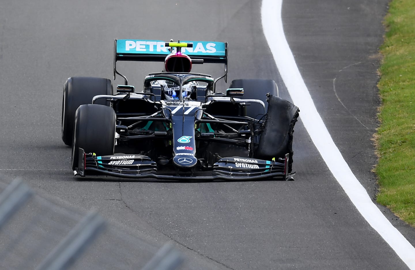 NORTHAMPTON, ENGLAND - AUGUST 02: Valtteri Bottas of Finland driving the (77) Mercedes AMG Petronas F1 Team Mercedes W11 with a punctured front left tyre during the F1 Grand Prix of Great Britain at Silverstone on August 02, 2020 in Northampton, England. (Photo by Clive Mason - Formula 1/Formula 1 via Getty Images)
