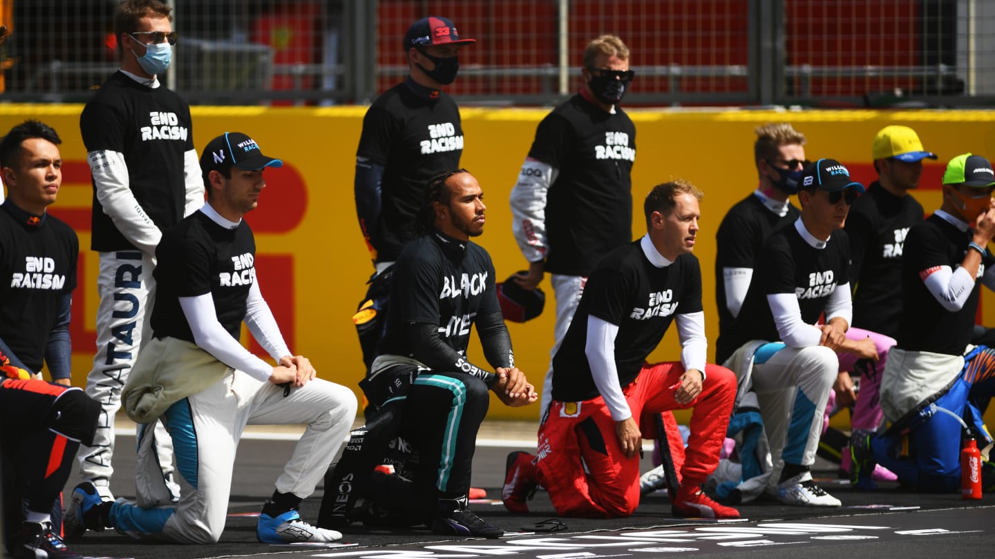 NORTHAMPTON, ENGLAND - AUGUST 02: F1 drivers kneel on the grid in support of the Black Lives Matter