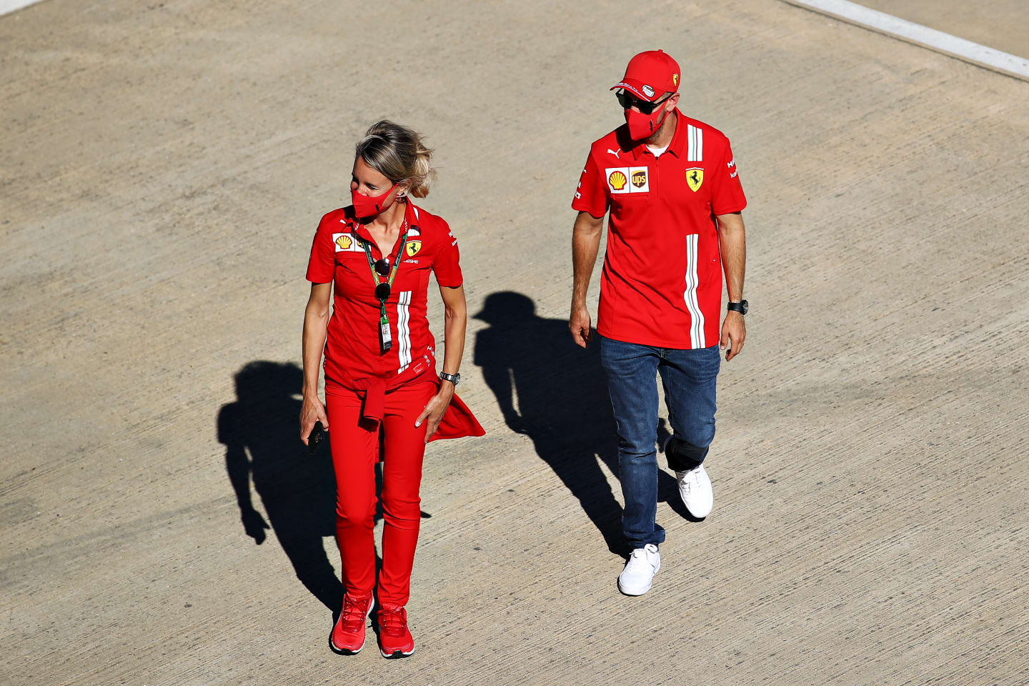 NORTHAMPTON, ENGLAND - JULY 30: Sebastian Vettel of Germany and Ferrari walks in the Paddock during