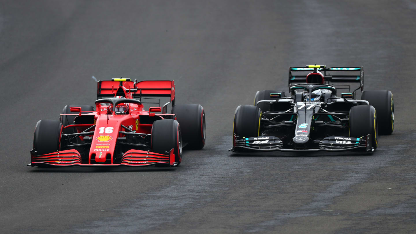 BUDAPEST, HUNGARY - JULY 19: Charles Leclerc of Monaco driving the (16) Scuderia Ferrari SF1000 and Valtteri Bottas of Finland driving the (77) Mercedes AMG Petronas F1 Team Mercedes W11 battle for position during the Formula One Grand Prix of Hungary at Hungaroring on July 19, 2020 in Budapest, Hungary. (Photo by Dan Istitene - Formula 1/Formula 1 via Getty Images)