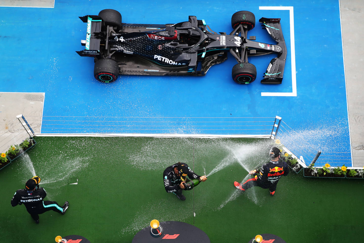 BUDAPEST, HUNGARY - JULY 19: Race winner Lewis Hamilton of Great Britain and Mercedes GP, second placed Max Verstappen of Netherlands and Red Bull Racing and third placed Valtteri Bottas of Finland and Mercedes GP celebrate on the podium after the Formula One Grand Prix of Hungary at Hungaroring on July 19, 2020 in Budapest, Hungary. (Photo by Mark Thompson/Getty Images)