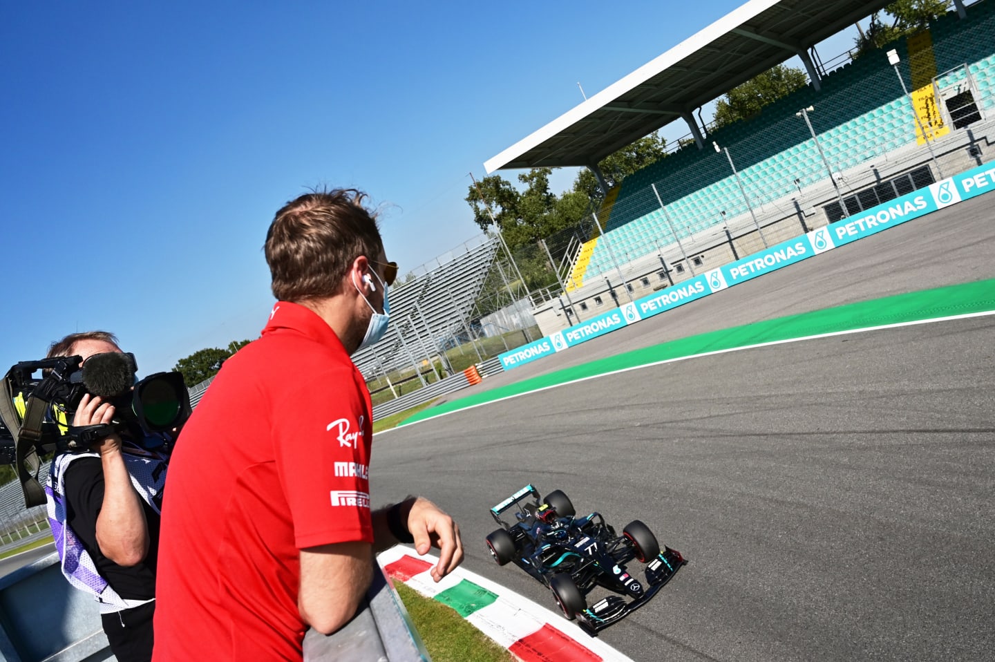 MONZA, ITALY - SEPTEMBER 05: Sebastian Vettel of Germany and Ferrari watches the action as Valtteri