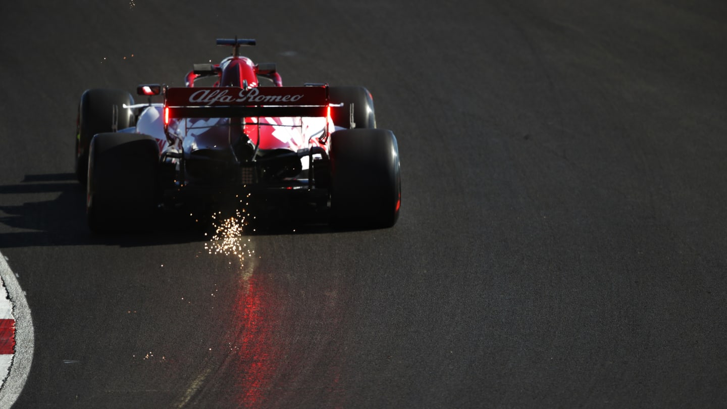 PORTIMAO, PORTUGAL - OCTOBER 23: Sparks fly behind Kimi Raikkonen of Finland driving the (7) Alfa Romeo Racing C39 Ferrari during practice ahead of the F1 Grand Prix of Portugal at Autodromo Internacional do Algarve on October 23, 2020 in Portimao, Portugal. (Photo by Bryn Lennon - Formula 1/Formula 1 via Getty Images)