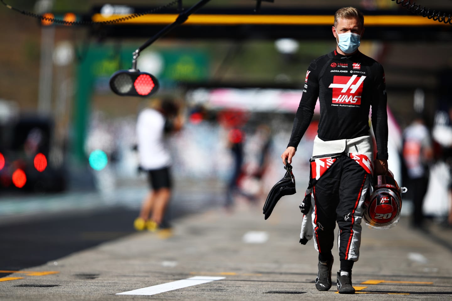 PORTIMAO, PORTUGAL - OCTOBER 24: Kevin Magnussen of Denmark and Haas F1 walks in the Pitlane during