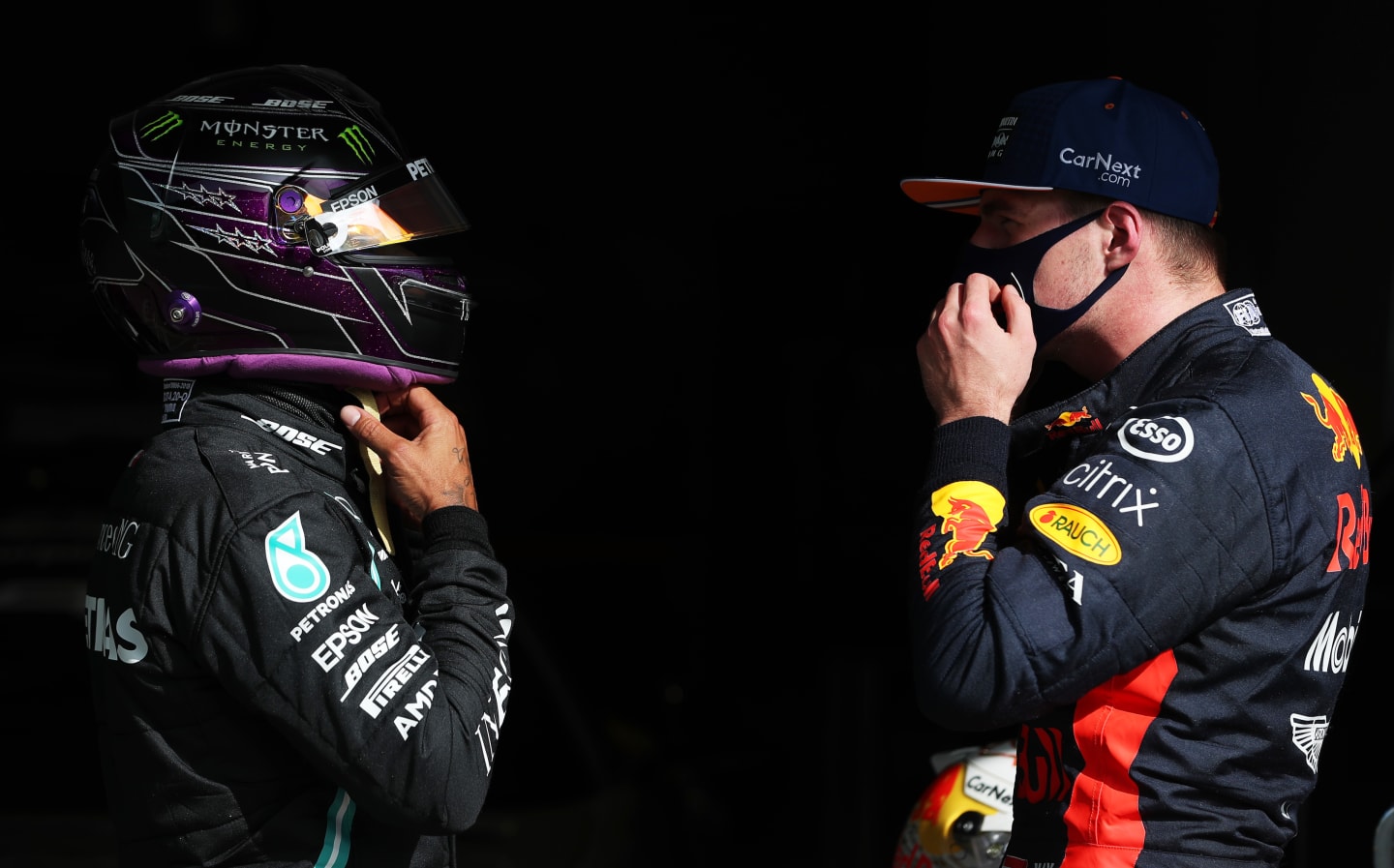 PORTIMAO, PORTUGAL - OCTOBER 24: Pole position qualifier Lewis Hamilton of Great Britain and Mercedes GP speaks with third placed Max Verstappen of Netherlands and Red Bull Racing in parc ferme during qualifying ahead of the F1 Grand Prix of Portugal at Autodromo Internacional do Algarve on October 24, 2020 in Portimao, Portugal. (Photo by Jose Sena Goulao - Pool/Getty Images)