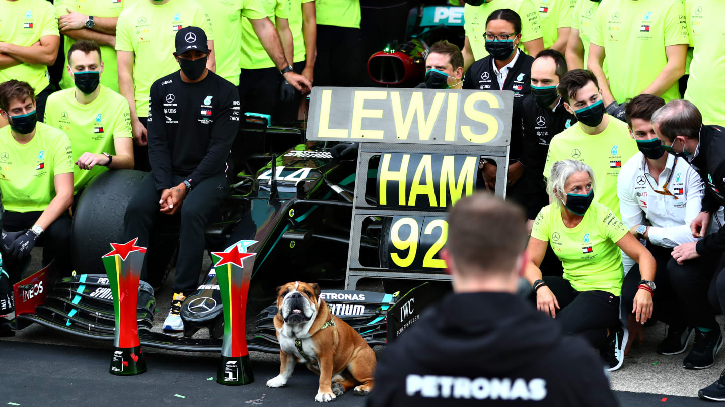 PORTIMAO, PORTUGAL - OCTOBER 25: Race winner Lewis Hamilton of Great Britain and Mercedes GP celebrates his record breaking 92nd race win with his dog Roscoe and his team after the F1 Grand Prix of Portugal at Autodromo Internacional do Algarve on October 25, 2020 in Portimao, Portugal. (Photo by Dan Istitene - Formula 1/Formula 1 via Getty Images)