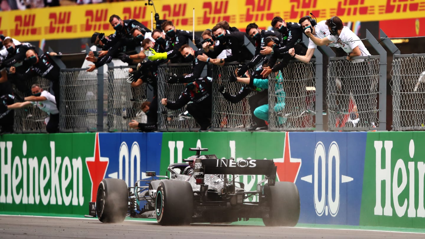 PORTIMAO, PORTUGAL - OCTOBER 25: The Mercedes GP team celebrate on the pitwall as Lewis Hamilton of