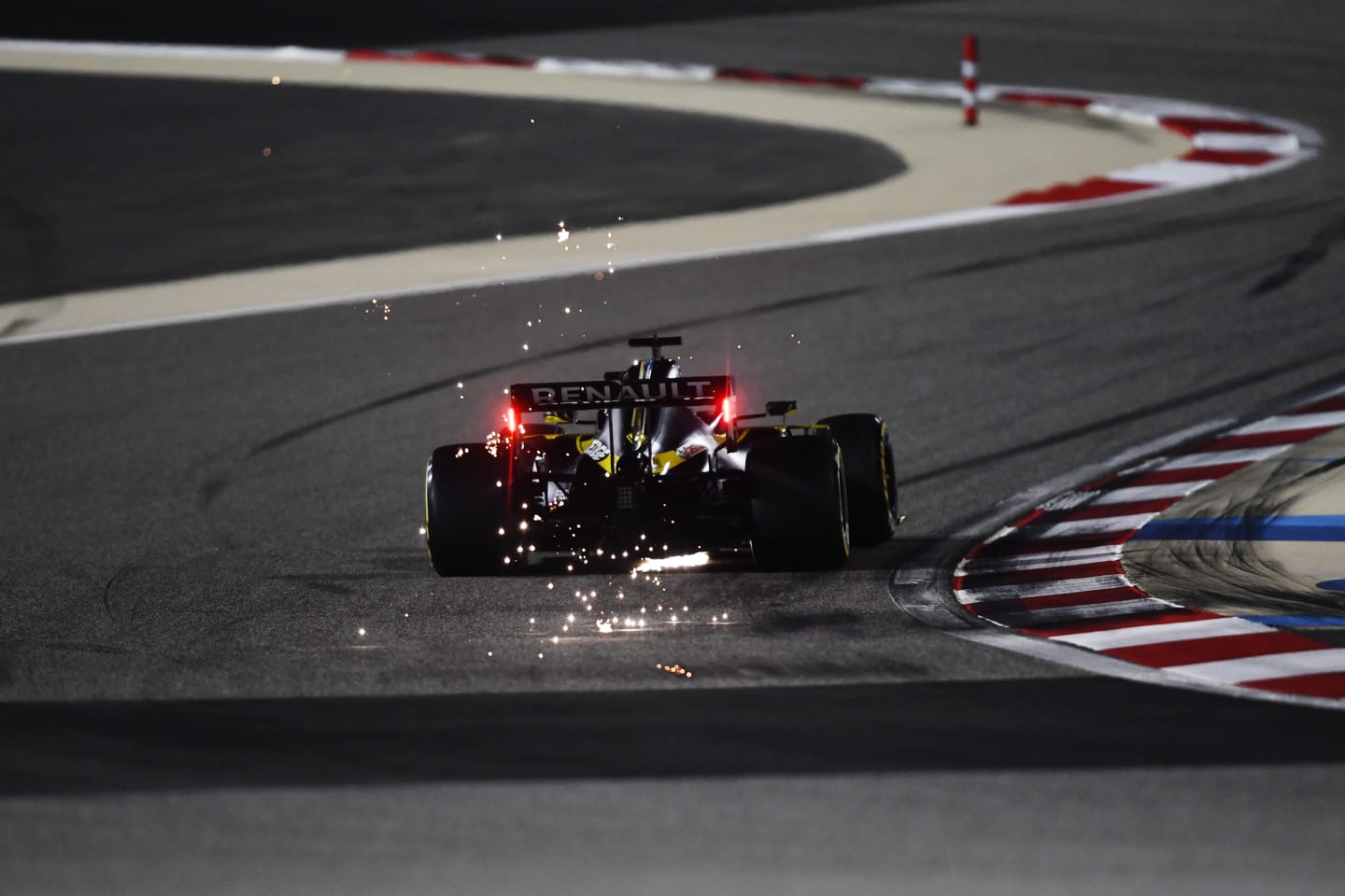 BAHRAIN, BAHRAIN - DECEMBER 04: Sparks fly behind Daniel Ricciardo of Australia driving the (3)