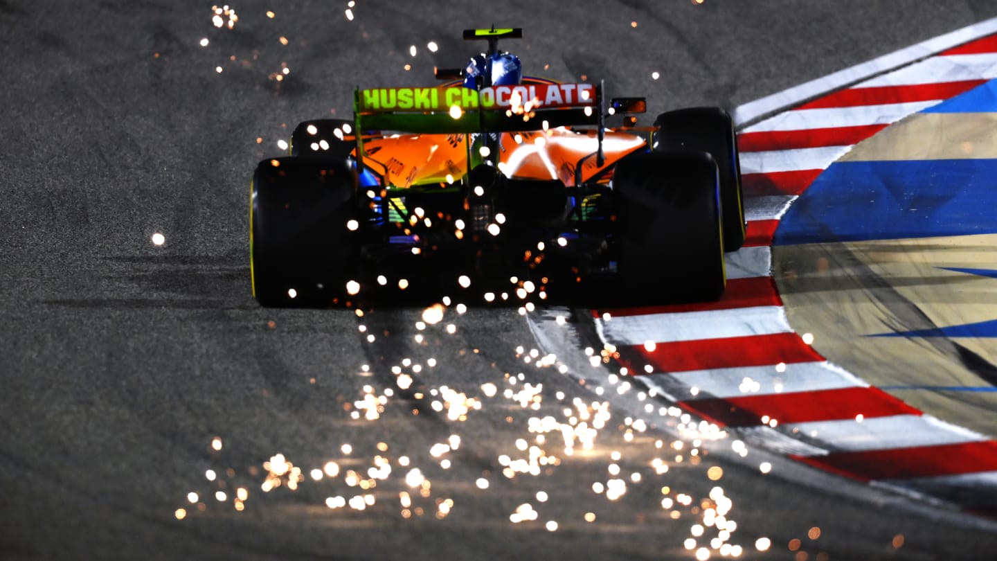 BAHRAIN, BAHRAIN - DECEMBER 04: Sparks fly behind Lando Norris of Great Britain driving the (4)