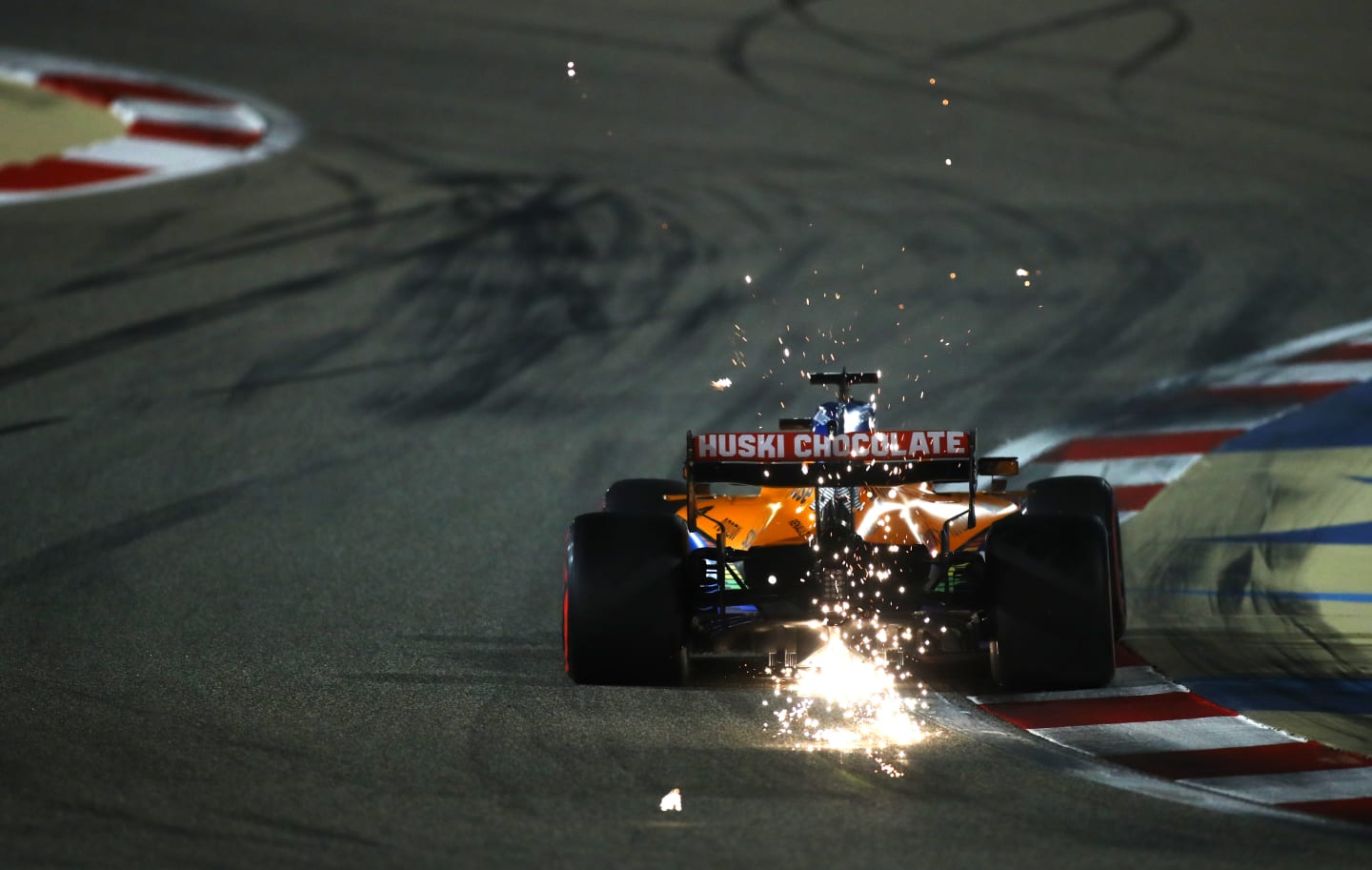 BAHRAIN, BAHRAIN - DECEMBER 05: Sparks fly behind Carlos Sainz of Spain driving the (55) McLaren F1