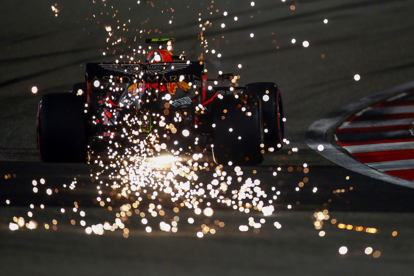 BAHRAIN, BAHRAIN - DECEMBER 05: Sparks fly behind Alexander Albon of Thailand driving the (23) Aston Martin Red Bull Racing RB16 during qualifying ahead of the F1 Grand Prix of Sakhir at Bahrain International Circuit on December 05, 2020 in Bahrain, Bahrain. (Photo by Bryn Lennon/Getty Images)