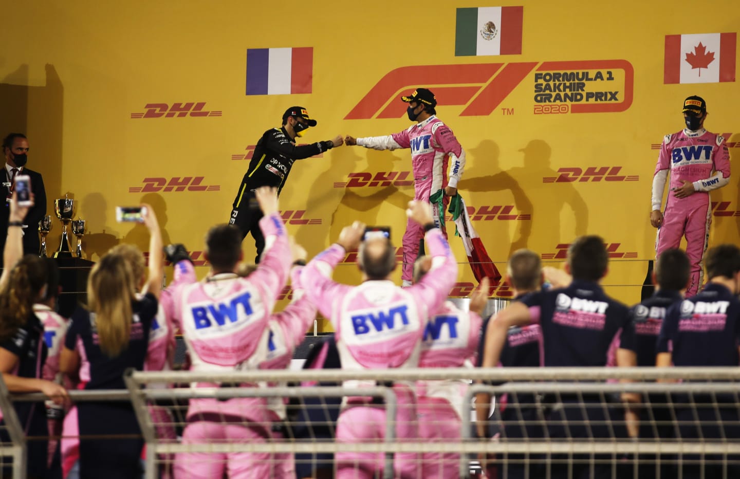 BAHRAIN, BAHRAIN - DECEMBER 06: Race winner Sergio Perez of Mexico and Racing Point and second placed Esteban Ocon of France and Renault Sport F1 celebrate on the podium during the F1 Grand Prix of Sakhir at Bahrain International Circuit on December 06, 2020 in Bahrain, Bahrain. (Photo by Hamad I Mohammed - Pool/Getty Images)