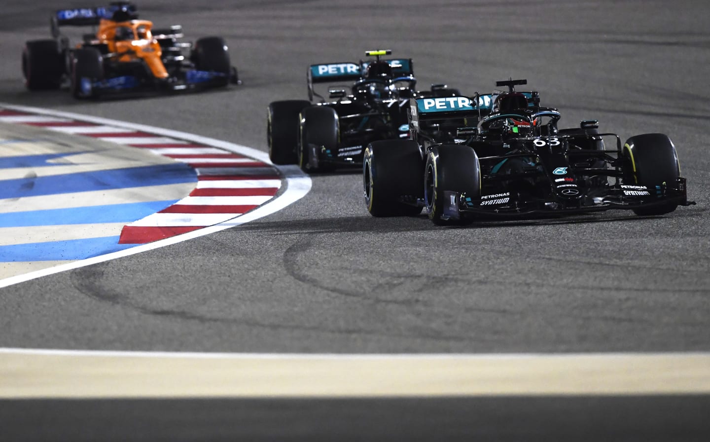 BAHRAIN, BAHRAIN - DECEMBER 06: George Russell of Great Britain driving the (63) Mercedes AMG Petronas F1 Team Mercedes W11 leads Valtteri Bottas of Finland driving the (77) Mercedes AMG Petronas F1 Team Mercedes W11 on track during the F1 Grand Prix of Sakhir at Bahrain International Circuit on December 06, 2020 in Bahrain, Bahrain. (Photo by Rudy Carezzevoli/Getty Images)