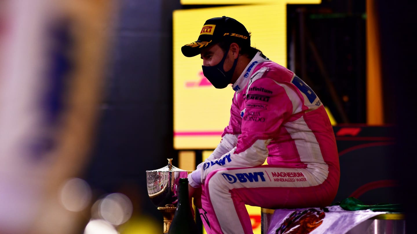 BAHRAIN, BAHRAIN - DECEMBER 06: Race winner Sergio Perez of Mexico and Racing Point celebrates his maiden F1 victory on the podium during the F1 Grand Prix of Sakhir at Bahrain International Circuit on December 06, 2020 in Bahrain, Bahrain. (Photo by Mario Renzi - Formula 1/Formula 1 via Getty Images)