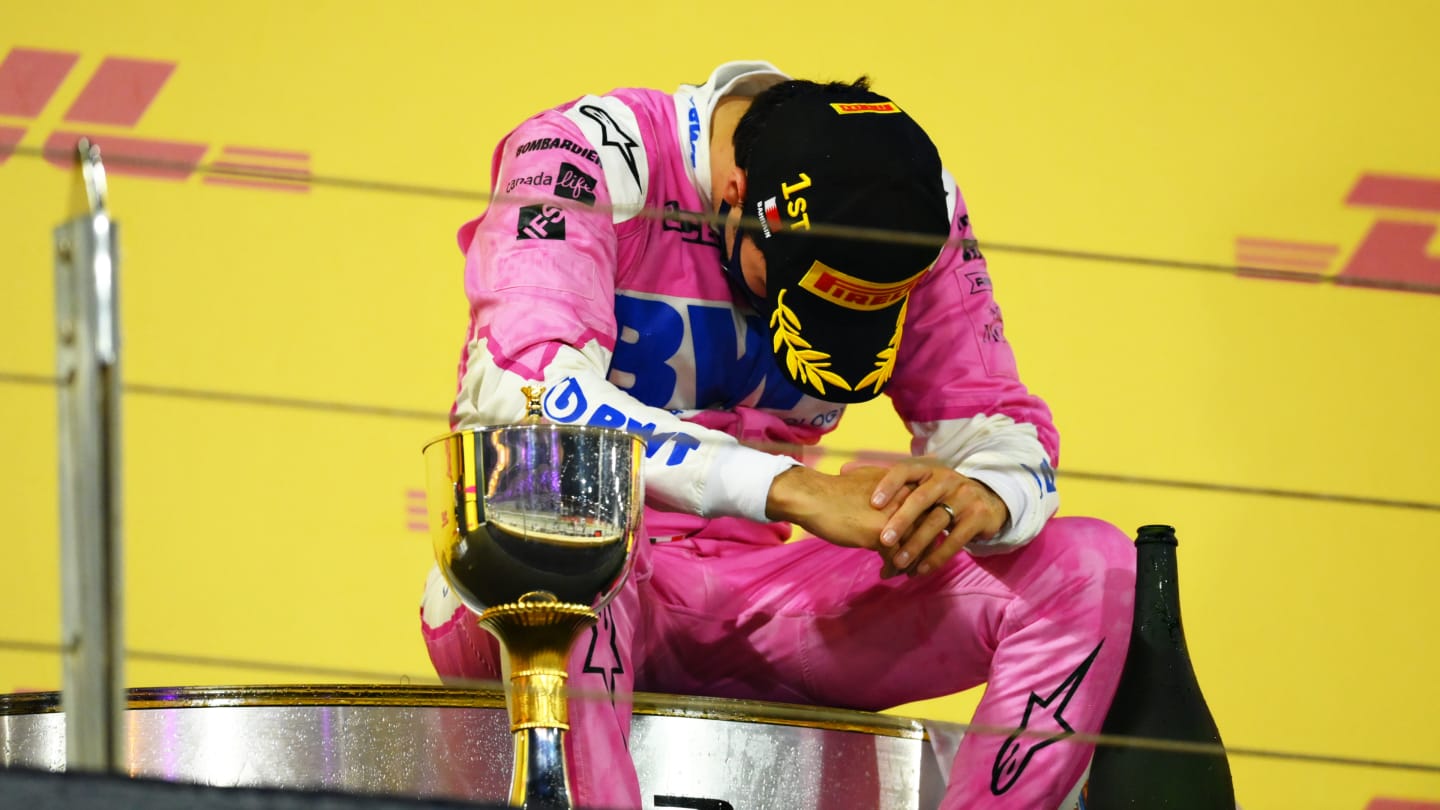 BAHRAIN, BAHRAIN - DECEMBER 06: Race winner Sergio Perez of Mexico and Racing Point celebrates his maiden F1 victory on the podium during the F1 Grand Prix of Sakhir at Bahrain International Circuit on December 06, 2020 in Bahrain, Bahrain. (Photo by Clive Mason - Formula 1/Formula 1 via Getty Images)
