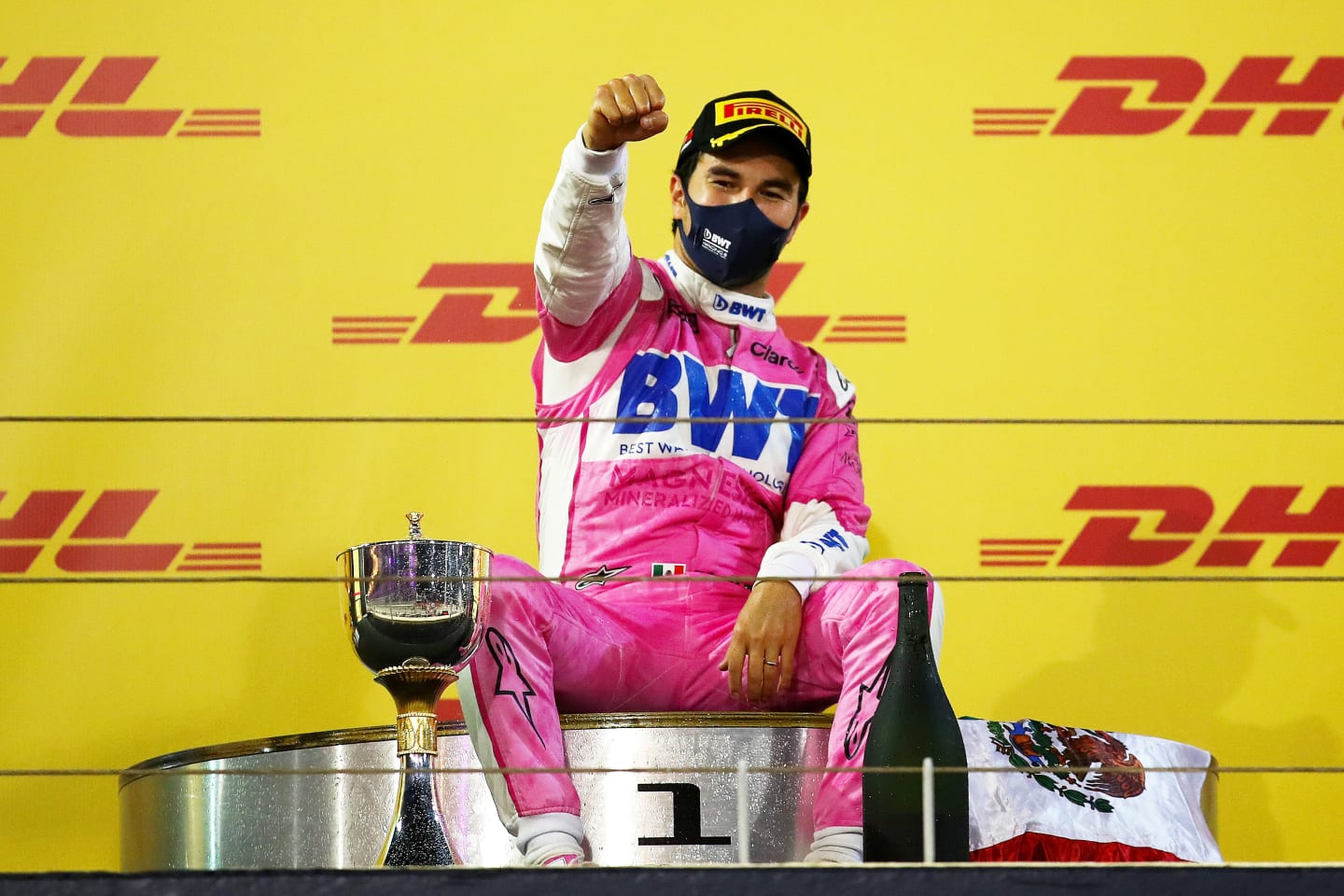 BAHRAIN, BAHRAIN - DECEMBER 06: Race winner Sergio Perez of Mexico and Racing Point celebrates his maiden F1 victory on the podium during the F1 Grand Prix of Sakhir at Bahrain International Circuit on December 06, 2020 in Bahrain, Bahrain. (Photo by Bryn Lennon/Getty Images)