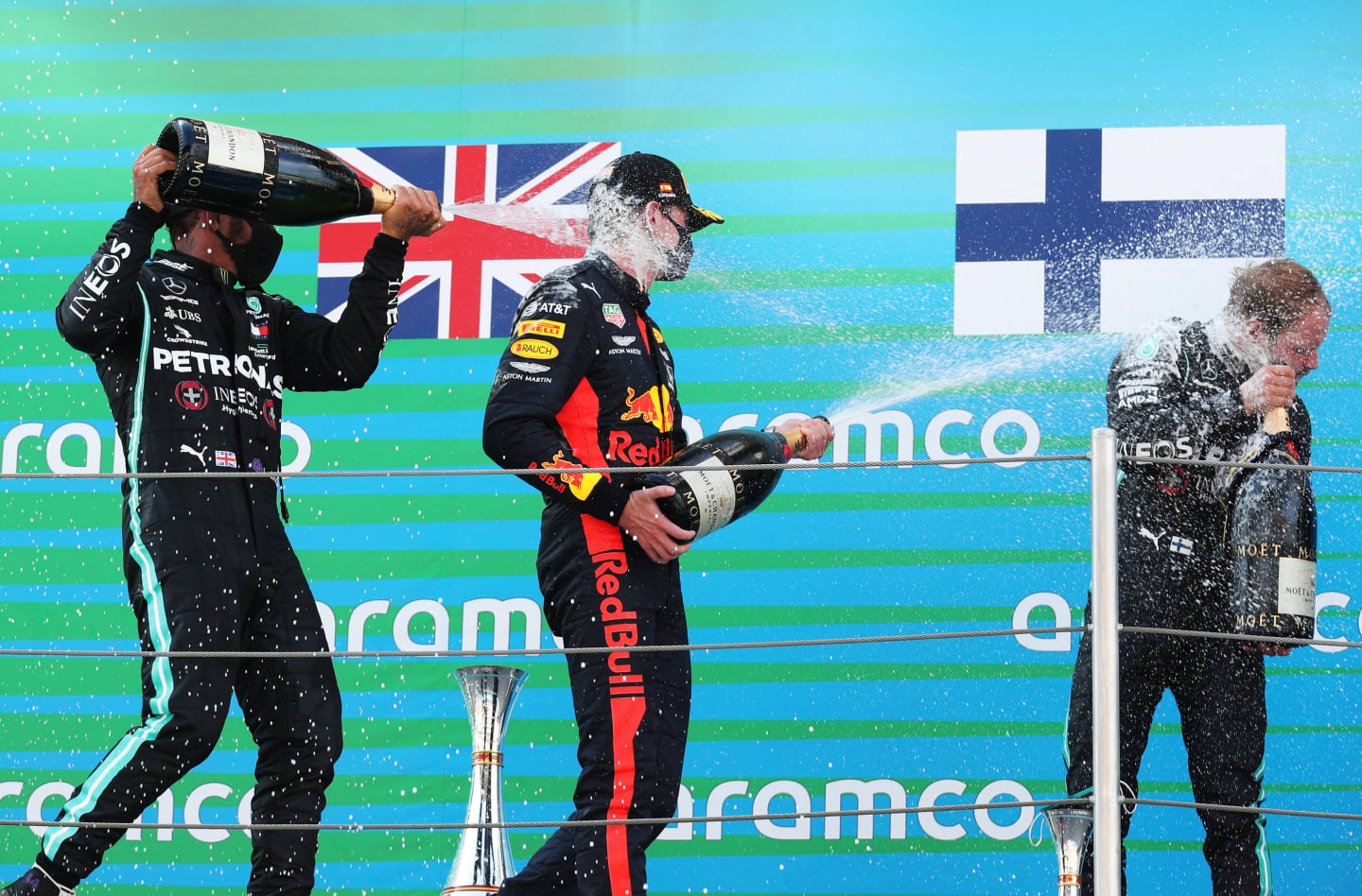 BARCELONA, SPAIN - AUGUST 16: Race winner Lewis Hamilton of Great Britain and Mercedes GP,  second placed Max Verstappen of Netherlands and Red Bull Racing and third placed Valtteri Bottas of Finland and Mercedes GP celebrate on the podium during the F1 Grand Prix of Spain at Circuit de Barcelona-Catalunya on August 16, 2020 in Barcelona, Spain. (Photo by Albert Gea/Pool via Getty Images)