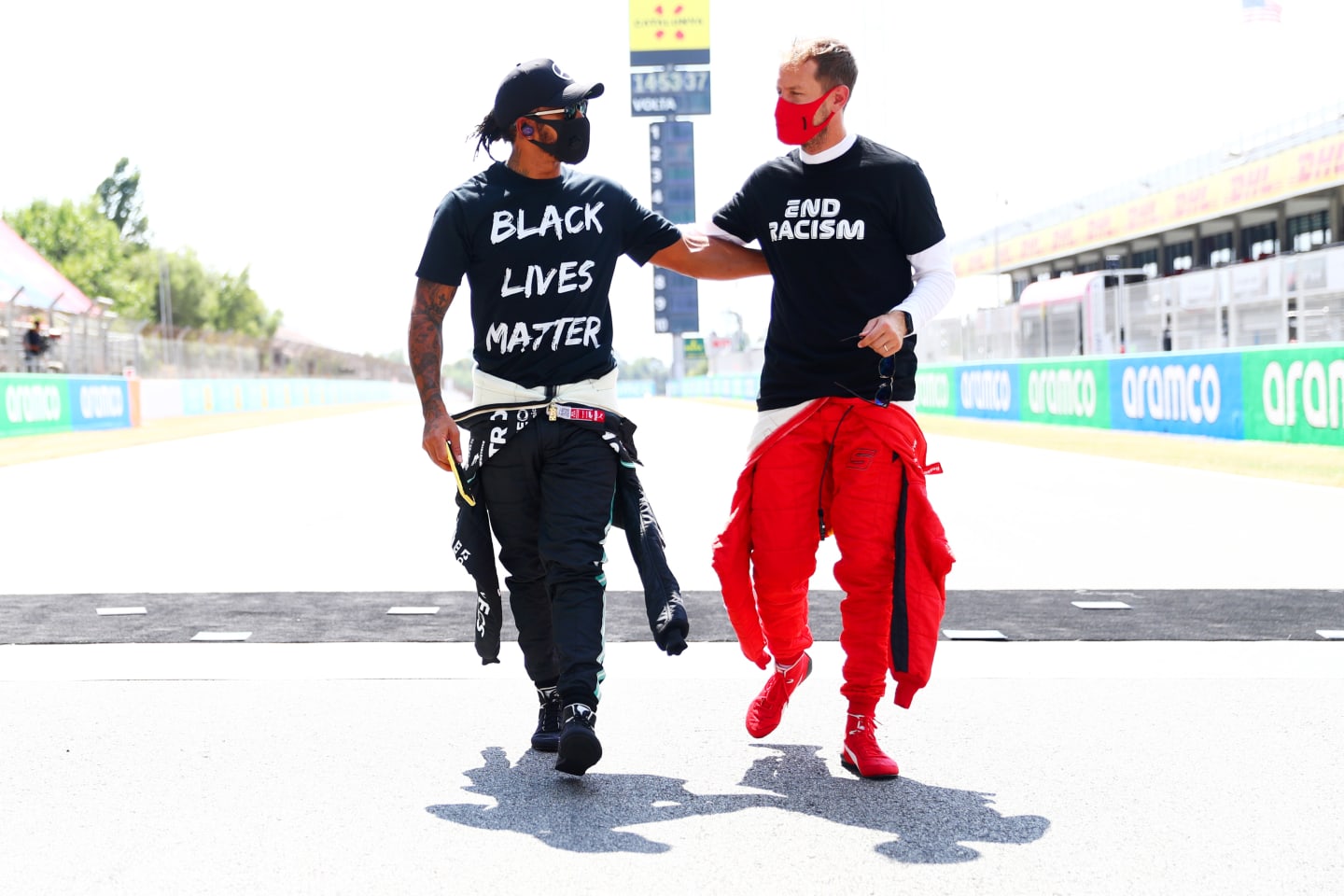 BARCELONA, SPAIN - AUGUST 16: Lewis Hamilton of Great Britain and Mercedes GP and Sebastian Vettel of Germany and Ferrari talk on the grid before the F1 Grand Prix of Spain at Circuit de Barcelona-Catalunya on August 16, 2020 in Barcelona, Spain. (Photo by Dan Istitene - Formula 1/Formula 1 via Getty Images)