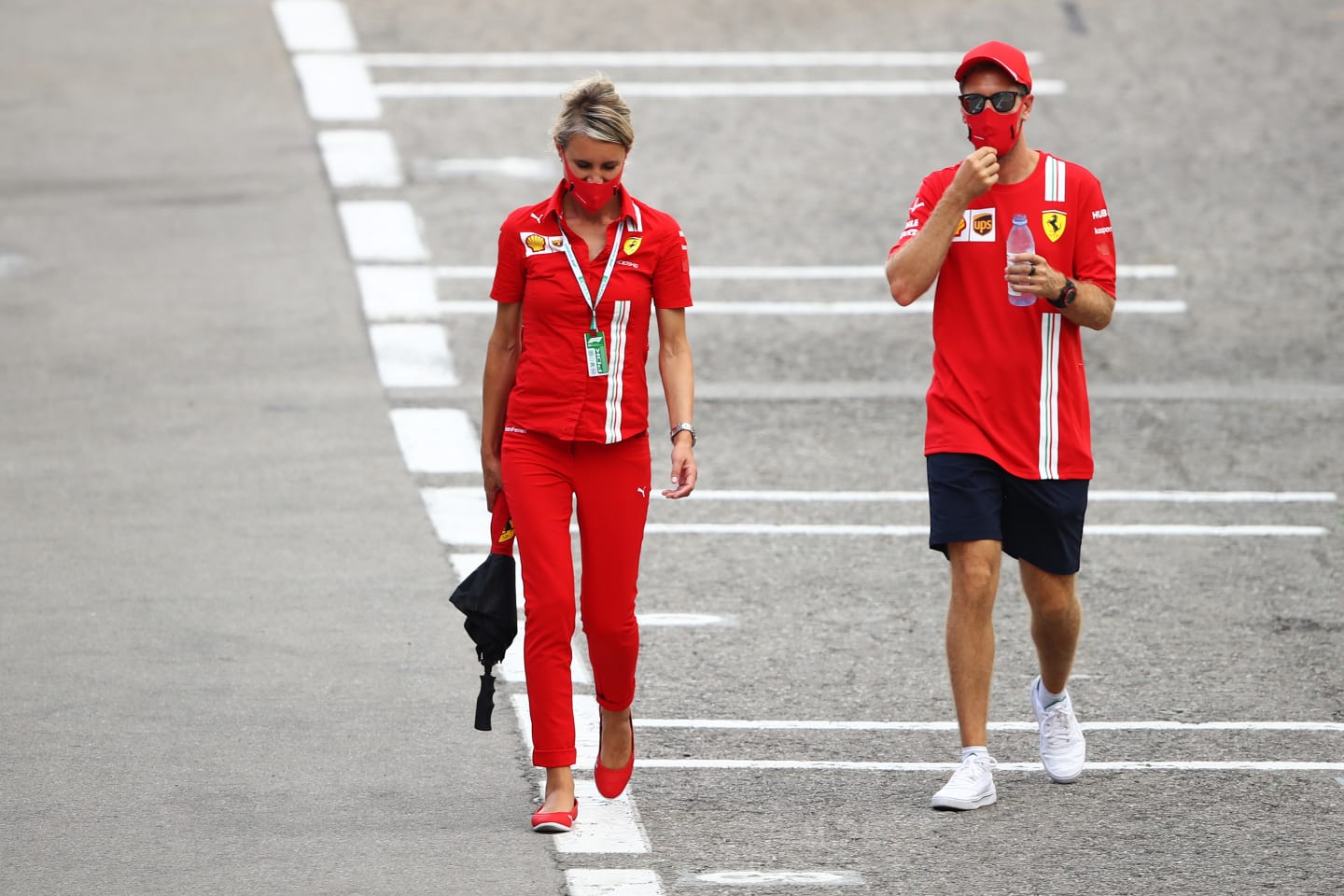 BARCELONA, SPAIN - AUGUST 13: Sebastian Vettel of Germany and Ferrari walks in the Paddock during