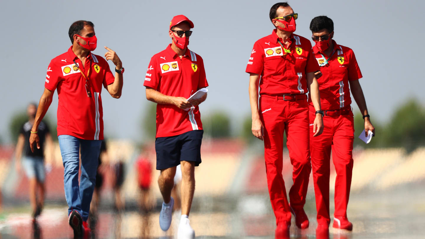 BARCELONA, SPAIN - AUGUST 13: Sebastian Vettel of Germany and Ferrari walks the track with his team