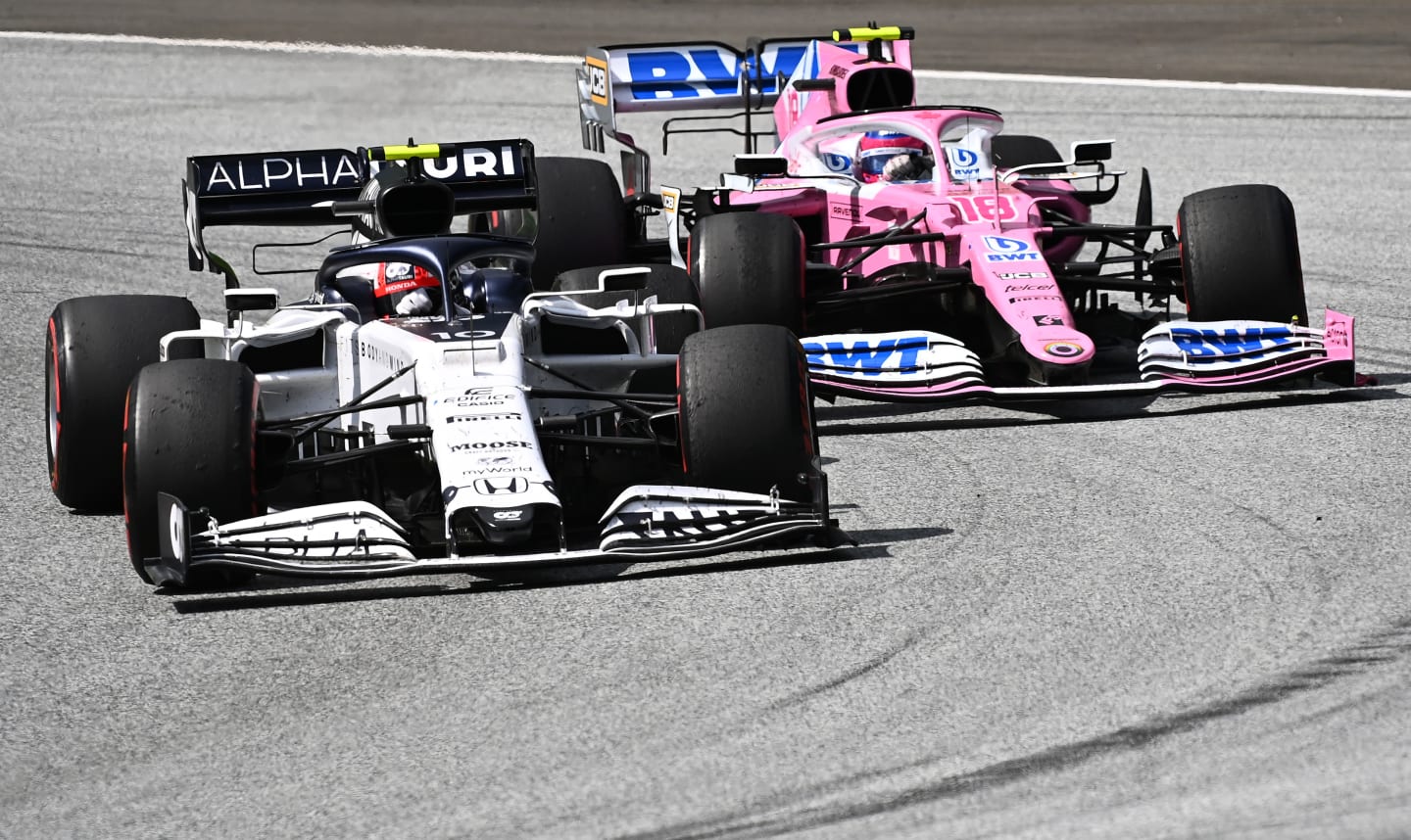 SPIELBERG, AUSTRIA - JULY 12: Pierre Gasly of France driving the (10) Scuderia AlphaTauri AT01 Honda battles for position with Lance Stroll of Canada driving the (18) Racing Point RP20 Mercedes during the Formula One Grand Prix of Styria at Red Bull Ring on July 12, 2020 in Spielberg, Austria. (Photo by Joe Klamar/Pool via Getty Images)