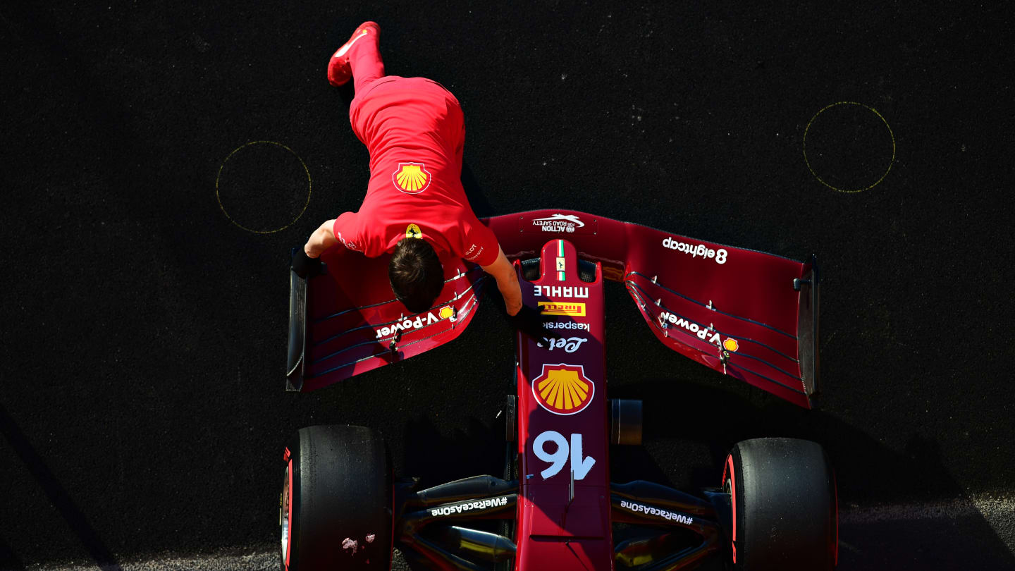 SCARPERIA, ITALY - SEPTEMBER 12: The Ferrari team work on the car of Charles Leclerc of Monaco and