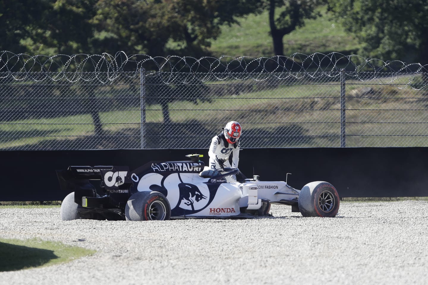 SCARPERIA, ITALY - SEPTEMBER 13: Pierre Gasly of France and Scuderia AlphaTauri climbs out of his