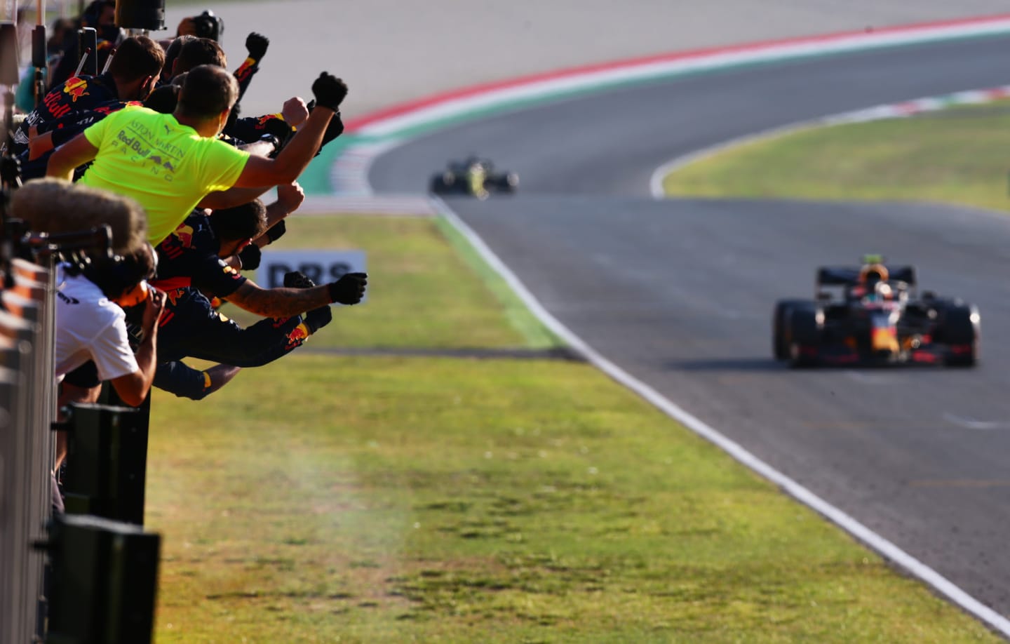 SCARPERIA, ITALY - SEPTEMBER 13: Red Bull Racing team members celebrate on the pitwall as Alexander