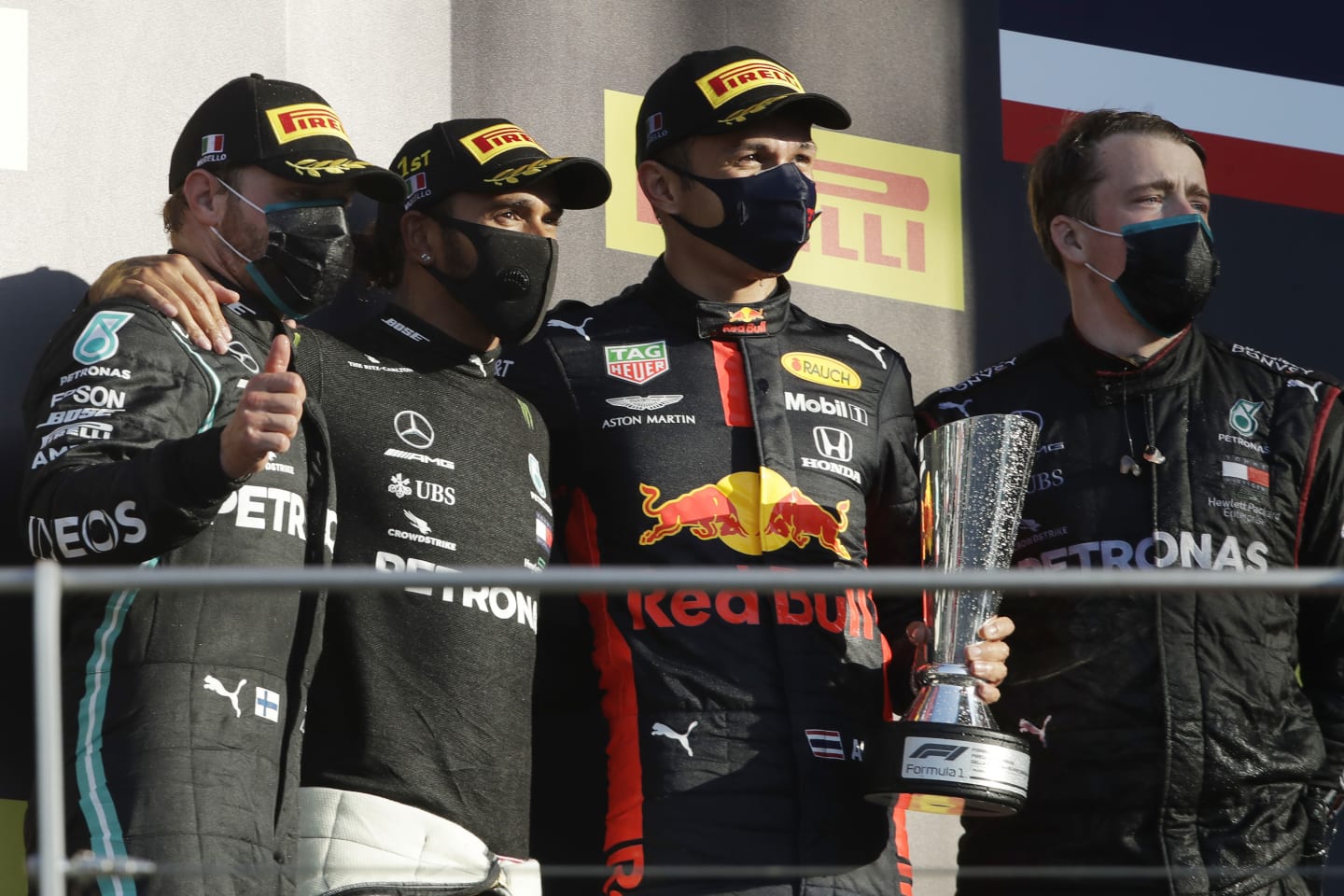 SCARPERIA, ITALY - SEPTEMBER 13: Race winner Lewis Hamilton of Great Britain and Mercedes GP, second placed Valtteri Bottas of Finland and Mercedes GP and third placed Alexander Albon of Thailand and Red Bull Racing celebrate on the podium during the F1 Grand Prix of Tuscany at Mugello Circuit on September 13, 2020 in Scarperia, Italy. (Photo by Luca Bruno - Pool/Getty Images)