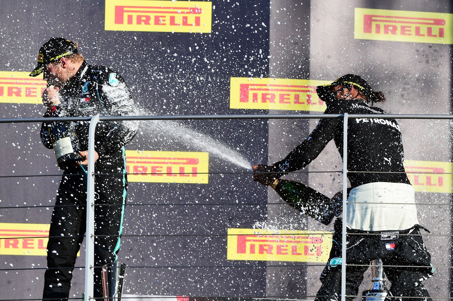 SCARPERIA, ITALY - SEPTEMBER 13: Race winner Lewis Hamilton of Great Britain and Mercedes GP and second placed Valtteri Bottas of Finland and Mercedes GP celebrate on the podium during the F1 Grand Prix of Tuscany at Mugello Circuit on September 13, 2020 in Scarperia, Italy. (Photo by Jenifer Lorenzini - Pool/Getty Images)