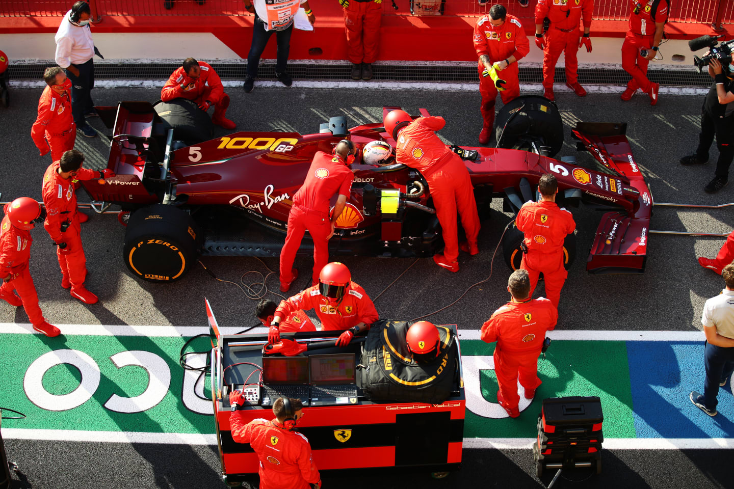 SCARPERIA, ITALY - SEPTEMBER 13: Scuderia Ferrari team members work on the car of Sebastian Vettel