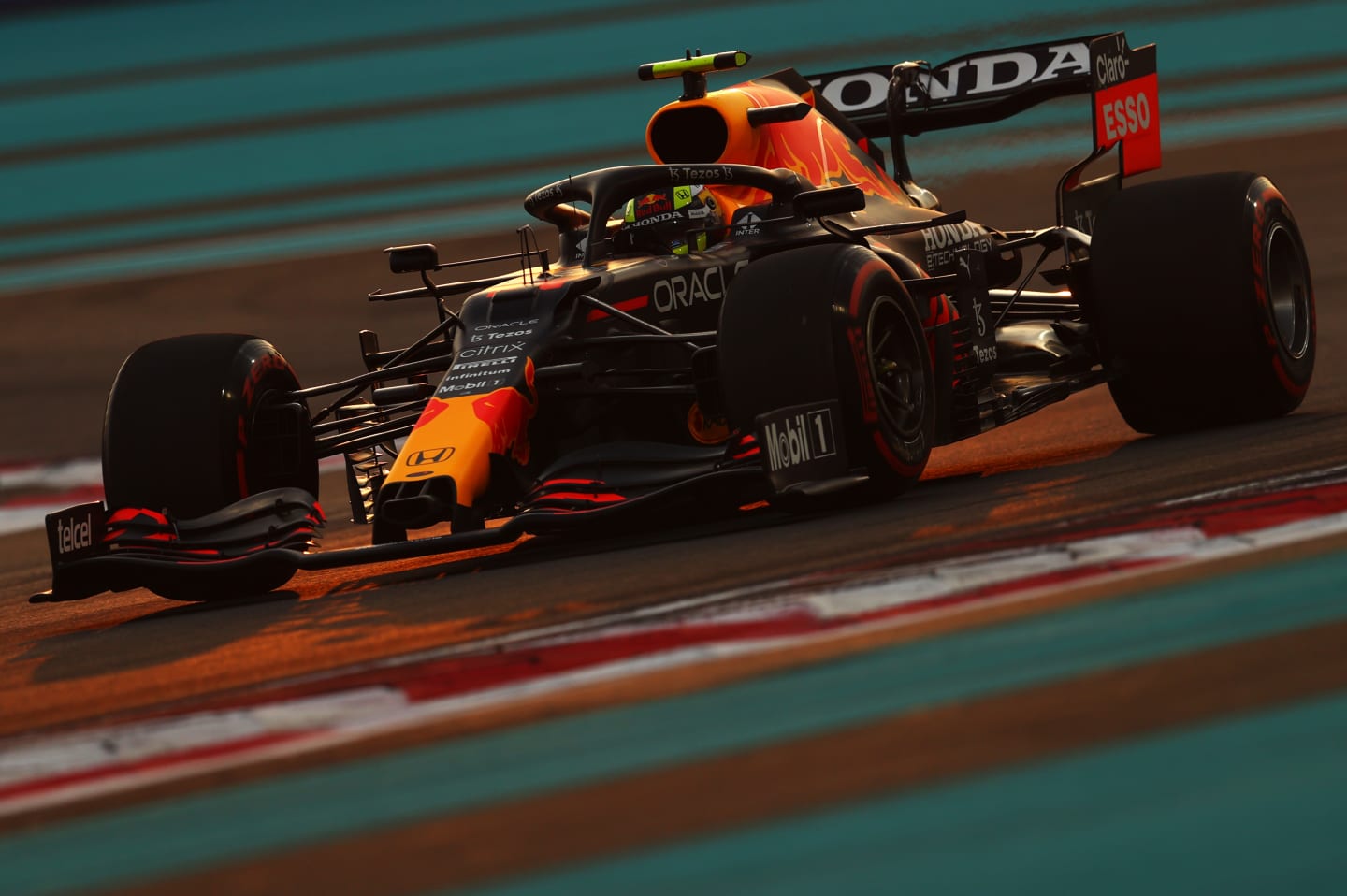 ABU DHABI, UNITED ARAB EMIRATES - DECEMBER 11: Sergio Perez of Mexico driving the (11) Red Bull Racing RB16B Honda during qualifying ahead of the F1 Grand Prix of Abu Dhabi at Yas Marina Circuit on December 11, 2021 in Abu Dhabi, United Arab Emirates. (Photo by Clive Rose/Getty Images)