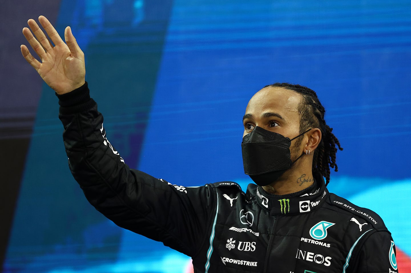 ABU DHABI, UNITED ARAB EMIRATES - DECEMBER 12: Second placed Lewis Hamilton of Great Britain and Mercedes GP waves from the podium during the F1 Grand Prix of Abu Dhabi at Yas Marina Circuit on December 12, 2021 in Abu Dhabi, United Arab Emirates. (Photo by Bryn Lennon/Getty Images)