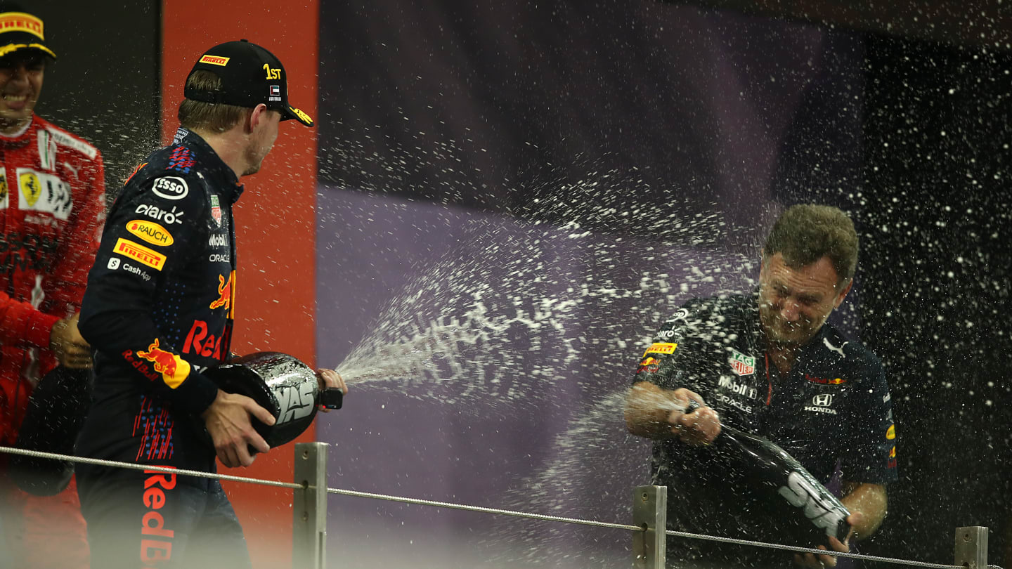 ABU DHABI, UNITED ARAB EMIRATES - DECEMBER 12: Race winner and 2021 F1 World Drivers Champion Max Verstappen of Netherlands and Red Bull Racing celebrates with Red Bull Racing Team Principal Christian Horner on the podium during the F1 Grand Prix of Abu Dhabi at Yas Marina Circuit on December 12, 2021 in Abu Dhabi, United Arab Emirates. (Photo by Joe Portlock - Formula 1/Formula 1 via Getty Images)