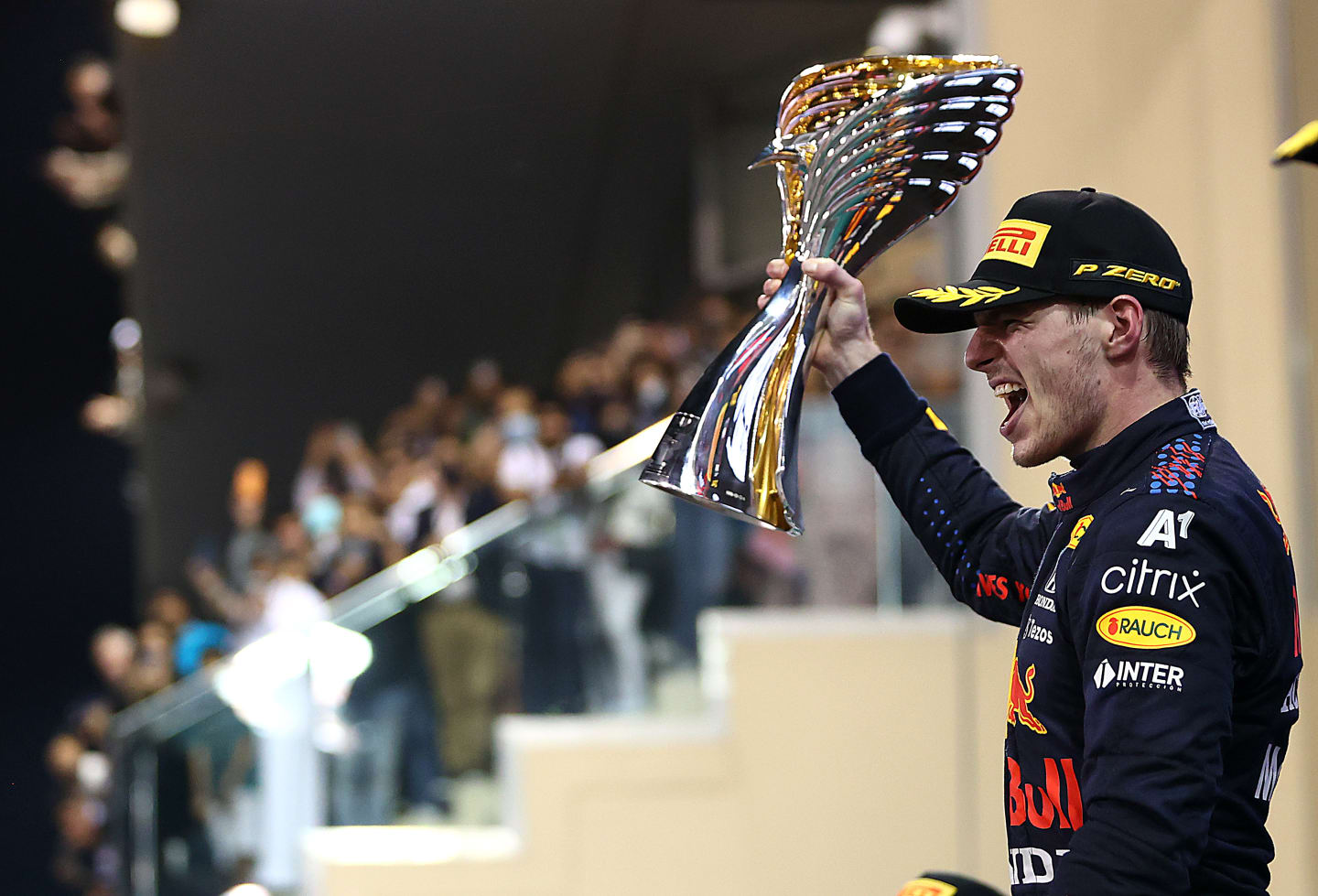 ABU DHABI, UNITED ARAB EMIRATES - DECEMBER 12: Race winner and 2021 F1 World Drivers Champion Max Verstappen of Netherlands and Red Bull Racing celebrates on the podium during the F1 Grand Prix of Abu Dhabi at Yas Marina Circuit on December 12, 2021 in Abu Dhabi, United Arab Emirates. (Photo by Dan Istitene - Formula 1/Formula 1 via Getty Images)