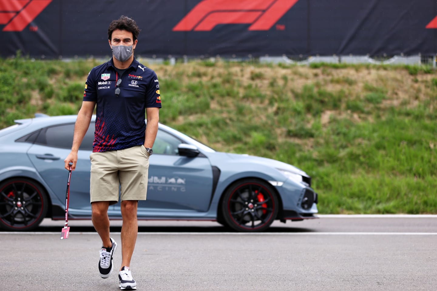 SPIELBERG, AUSTRIA - JULY 01: Sergio Perez of Mexico and Red Bull Racing walks in the Paddock