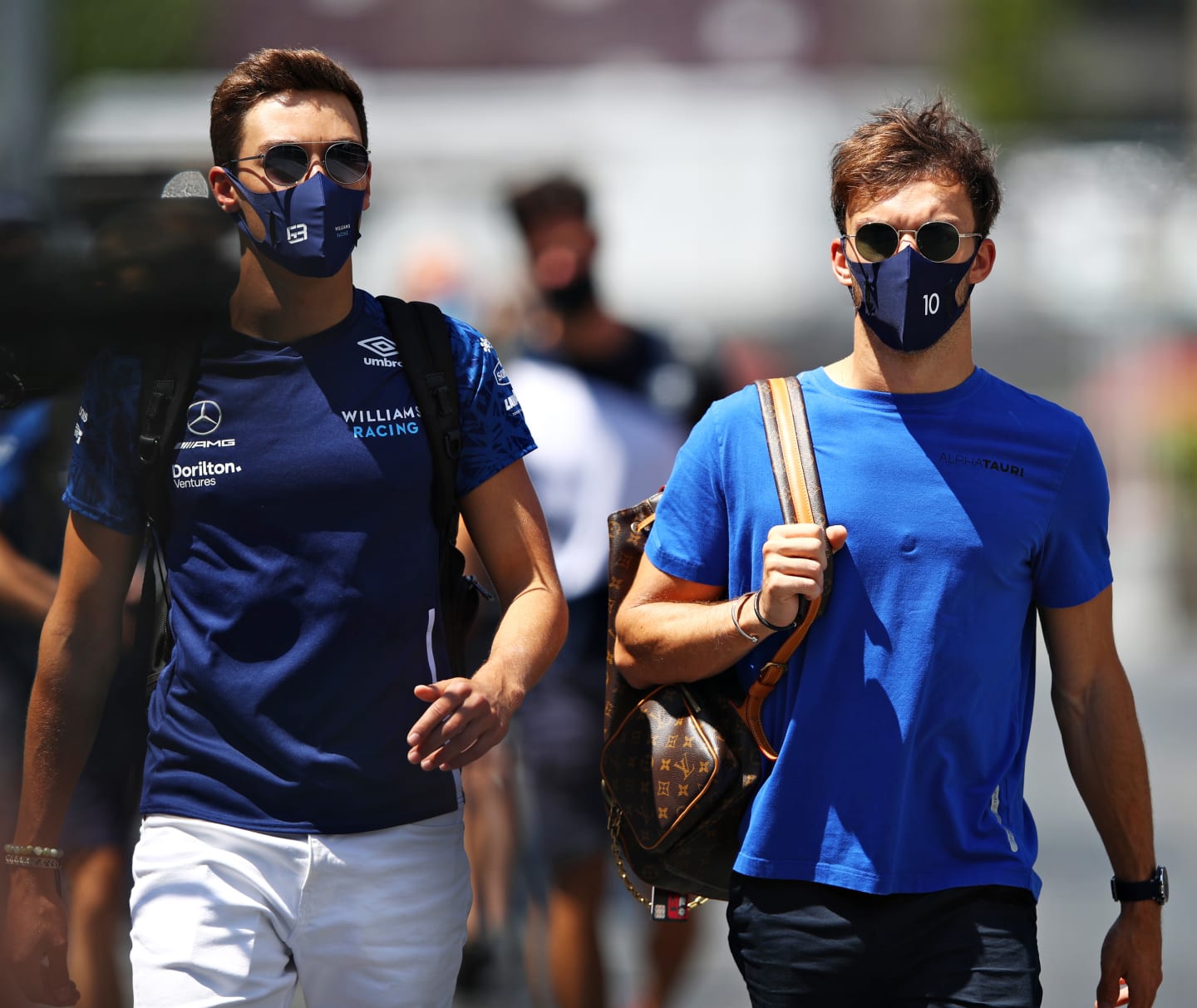 BAKU, AZERBAIJAN - JUNE 05: George Russell of Great Britain and Williams and Pierre Gasly of France and Scuderia AlphaTauri walk in the Paddock before final practice ahead of the F1 Grand Prix of Azerbaijan at Baku City Circuit on June 05, 2021 in Baku, Azerbaijan. (Photo by Mark Thompson/Getty Images)