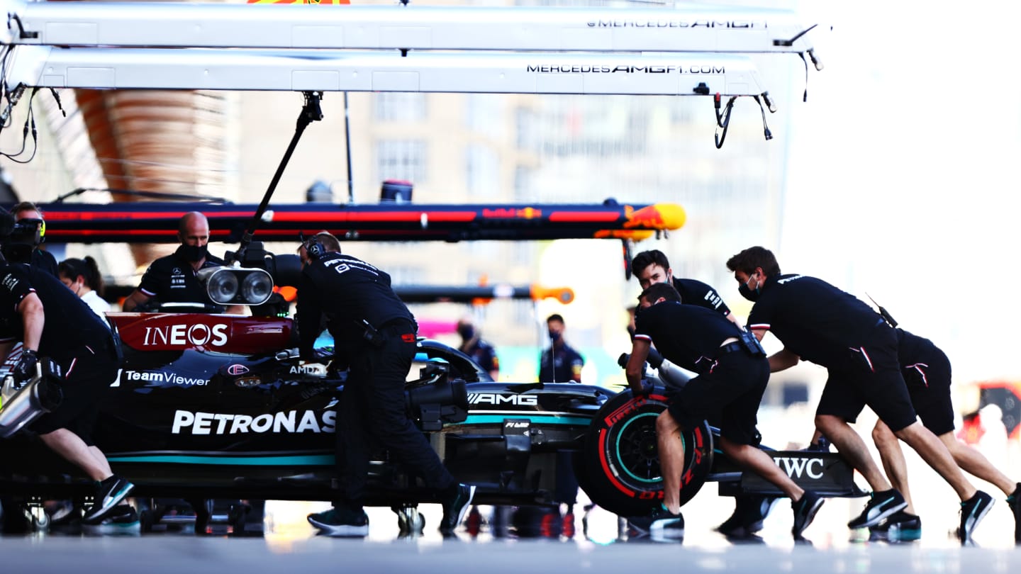 BAKU, AZERBAIJAN - JUNE 05: Lewis Hamilton of Great Britain driving the (44) Mercedes AMG Petronas F1 Team Mercedes W12 is pushed back into the garage during qualifying ahead of the F1 Grand Prix of Azerbaijan at Baku City Circuit on June 05, 2021 in Baku, Azerbaijan. (Photo by Dan Istitene - Formula 1/Formula 1 via Getty Images)