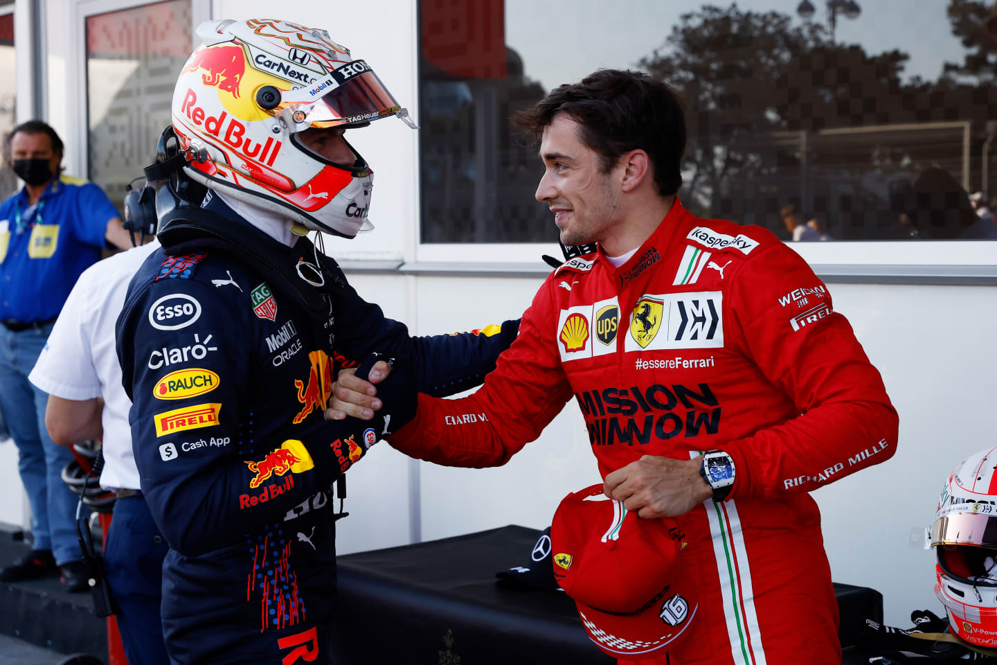 BAKU, AZERBAIJAN - JUNE 05: Third placed qualifier Max Verstappen of Netherlands and Red Bull Racing shakes hands with pole position qualifier Charles Leclerc of Monaco and Ferrari in parc ferme during qualifying ahead of the F1 Grand Prix of Azerbaijan at Baku City Circuit on June 05, 2021 in Baku, Azerbaijan. (Photo by Maxim Shemetov - Pool/Getty Images)