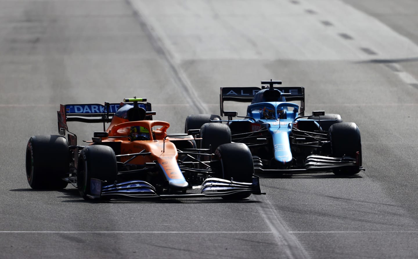 BAKU, AZERBAIJAN - JUNE 06: Lando Norris of Great Britain driving the (4) McLaren F1 Team MCL35M Mercedes and Fernando Alonso of Spain driving the (14) Alpine A521 Renault on track during the F1 Grand Prix of Azerbaijan at Baku City Circuit on June 06, 2021 in Baku, Azerbaijan. (Photo by Francois Nel/Getty Images)