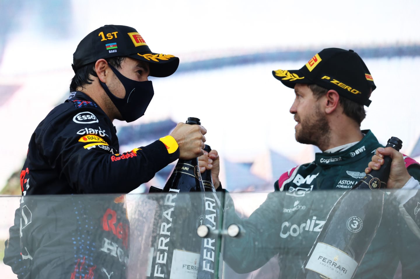 BAKU, AZERBAIJAN - JUNE 06: Race winner Sergio Perez of Mexico and Red Bull Racing and second placed Sebastian Vettel of Germany and Aston Martin F1 Team celebrate with sparkling wine on the podium during the F1 Grand Prix of Azerbaijan at Baku City Circuit on June 06, 2021 in Baku, Azerbaijan. (Photo by Clive Rose/Getty Images)