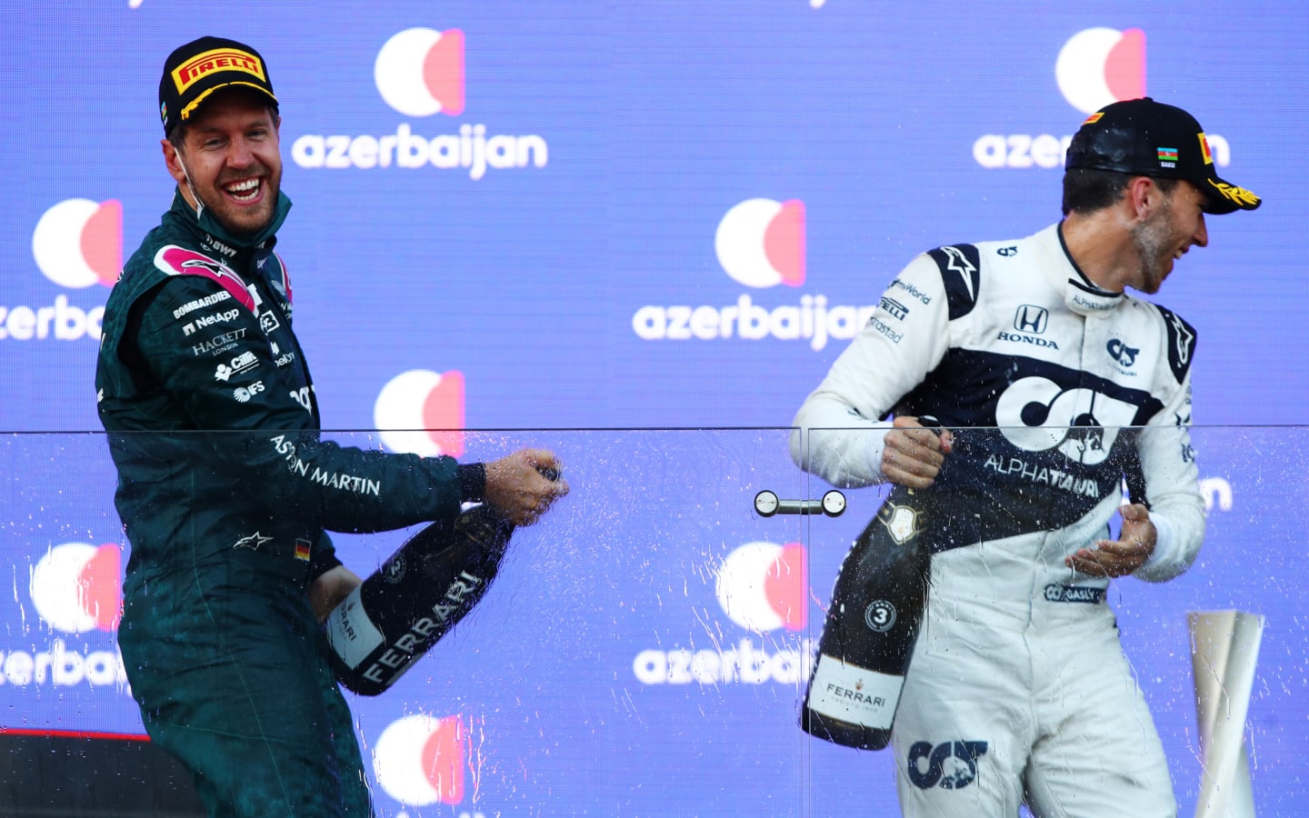 BAKU, AZERBAIJAN - JUNE 06: Second placed Sebastian Vettel of Germany and Aston Martin F1 Team and third placed Pierre Gasly of France and Scuderia AlphaTauri celebrate on the podium during the F1 Grand Prix of Azerbaijan at Baku City Circuit on June 06, 2021 in Baku, Azerbaijan. (Photo by Mark Thompson/Getty Images)