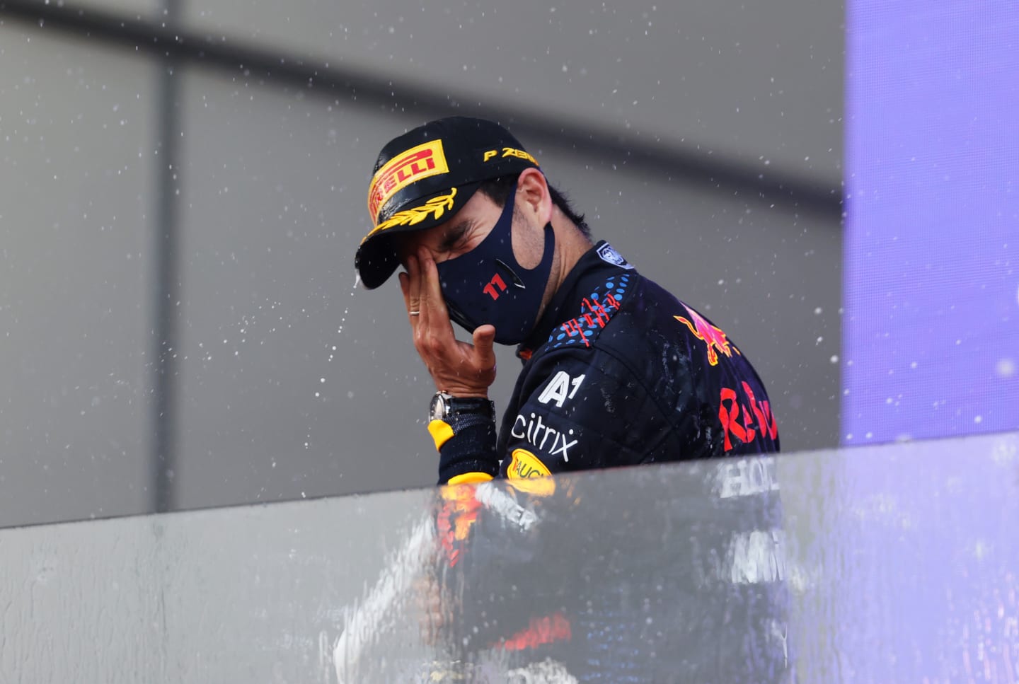 BAKU, AZERBAIJAN - JUNE 06: Race winner Sergio Perez of Mexico and Red Bull Racing celebrates with sparkling wine on the podium during the F1 Grand Prix of Azerbaijan at Baku City Circuit on June 06, 2021 in Baku, Azerbaijan. (Photo by Clive Rose/Getty Images)