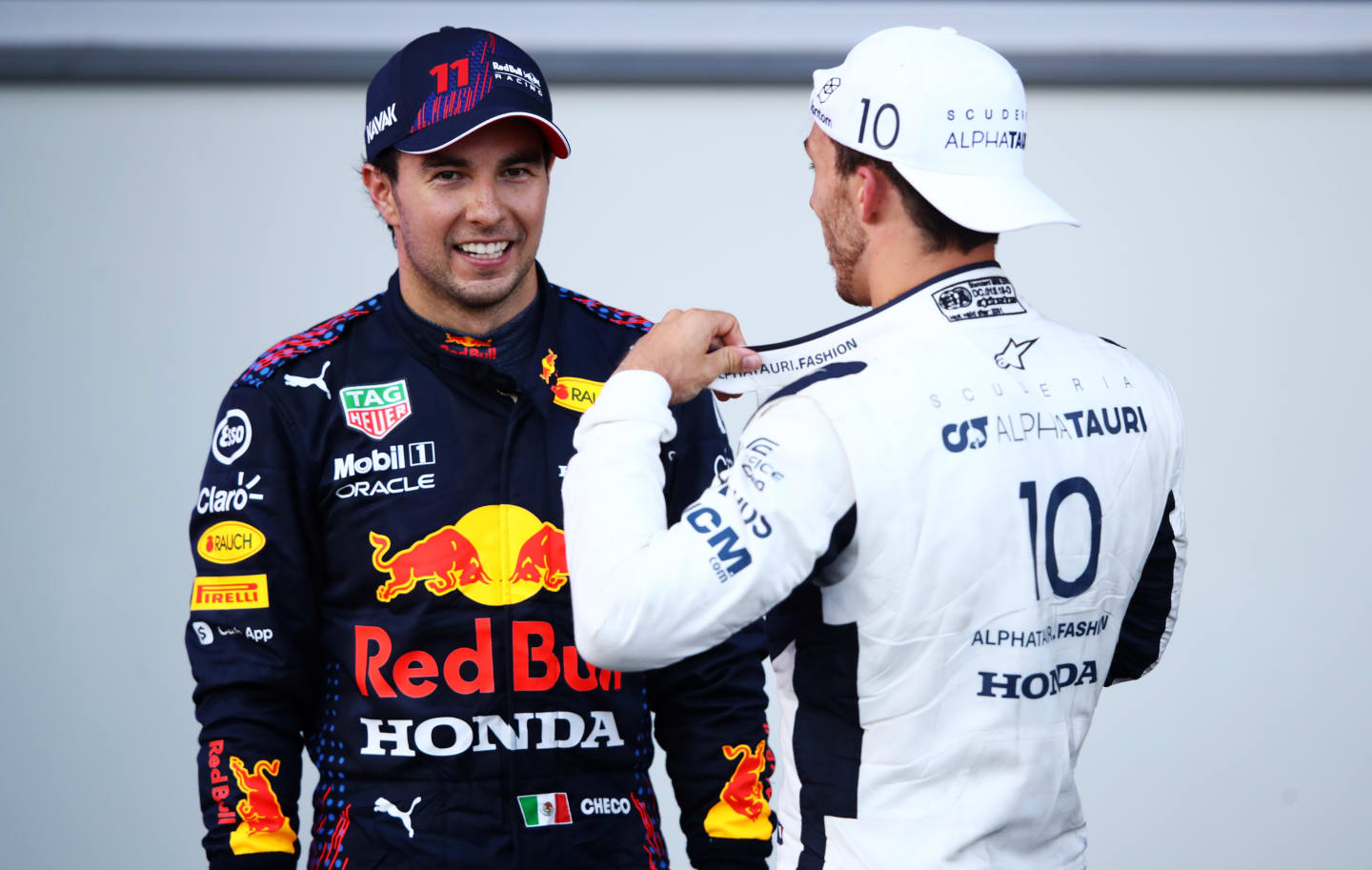 BAKU, AZERBAIJAN - JUNE 06: Race winner Sergio Perez of Mexico and Red Bull Racing and third placed Pierre Gasly of France and Scuderia AlphaTauri talk in parc ferme during the F1 Grand Prix of Azerbaijan at Baku City Circuit on June 06, 2021 in Baku, Azerbaijan. (Photo by Mark Thompson/Getty Images)