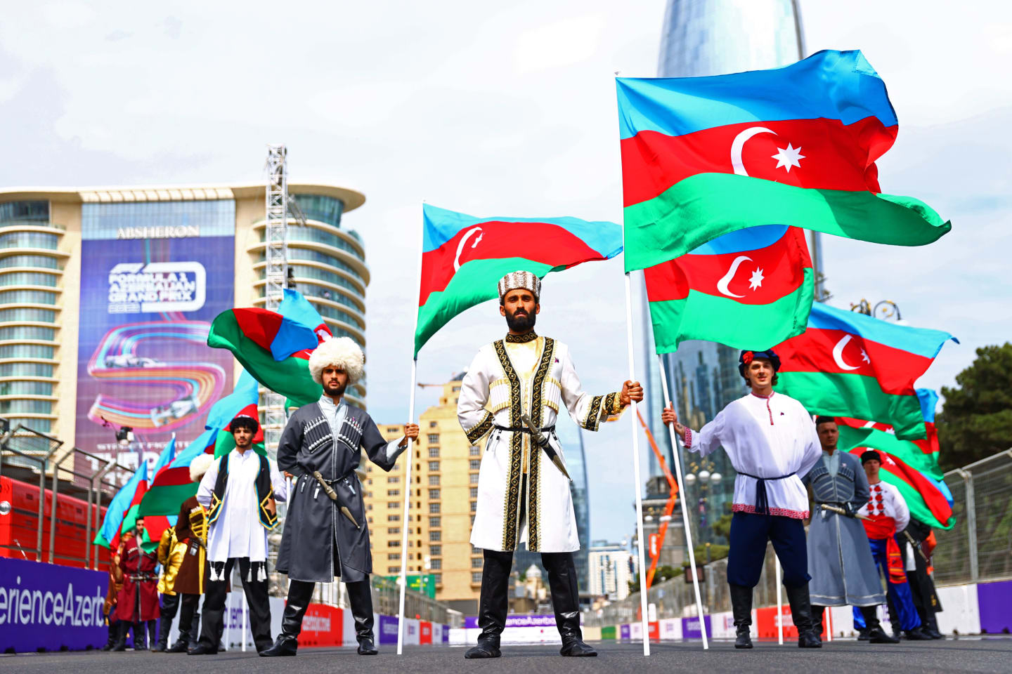 BAKU, AZERBAIJAN - JUNE 06: Performers holding the Azerbaijan flag stand on the grid before the F1