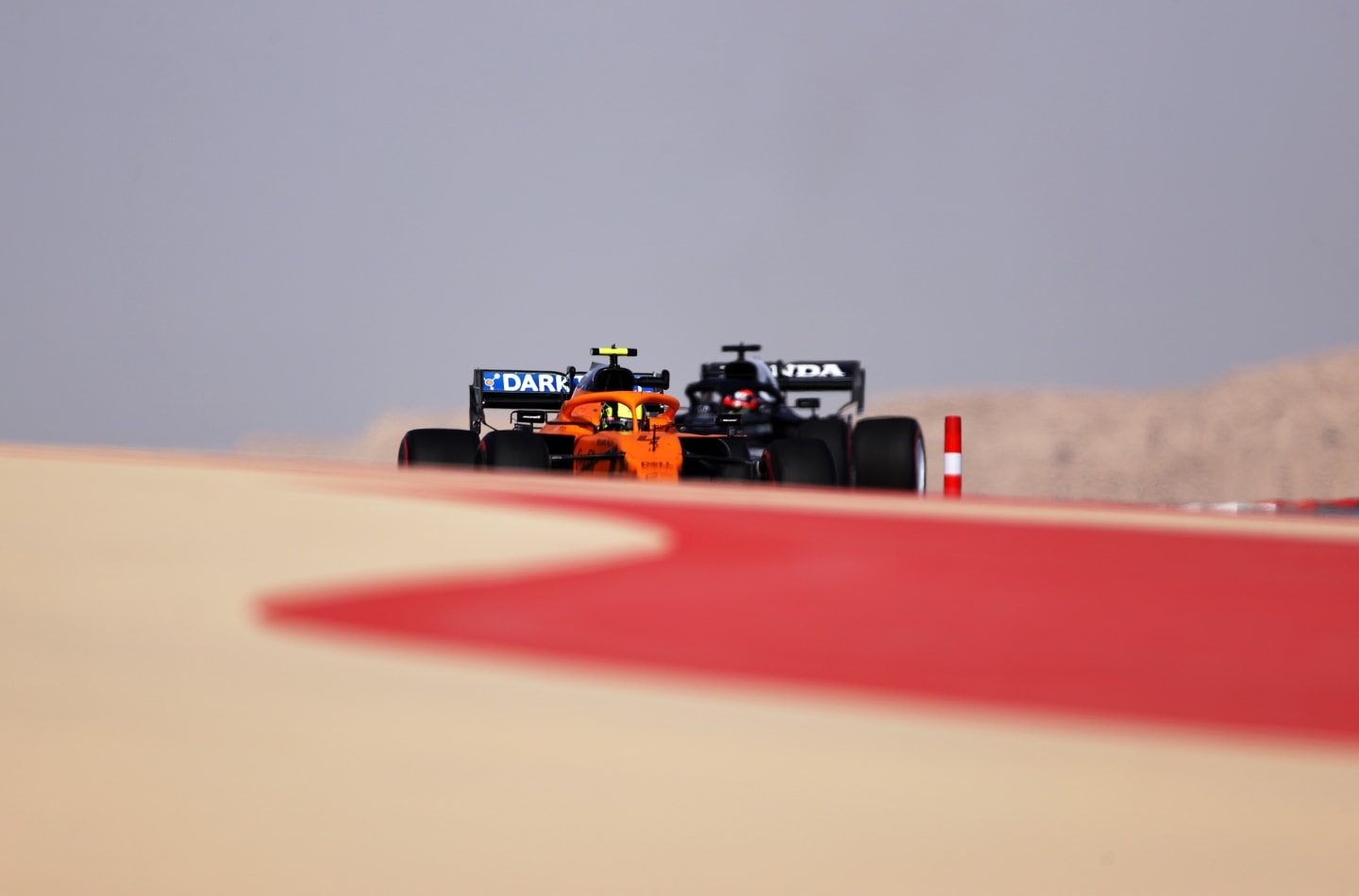 BAHRAIN, BAHRAIN - MARCH 26: Lando Norris of Great Britain driving the (4) McLaren F1 Team MCL35M Mercedes and Yuki Tsunoda of Japan driving the (22) Scuderia AlphaTauri AT02 Honda drive on track during practice ahead of the F1 Grand Prix of Bahrain at Bahrain International Circuit on March 26, 2021 in Bahrain, Bahrain. (Photo by Lars Baron/Getty Images)
