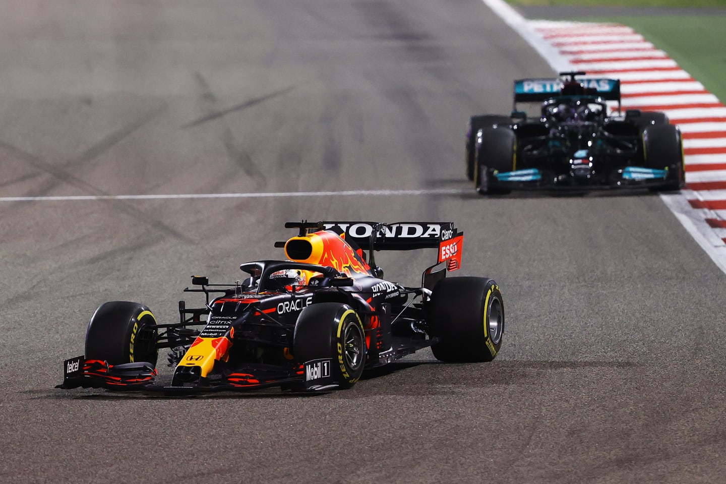 BAHRAIN, BAHRAIN - MARCH 28: Max Verstappen of the Netherlands driving the (33) Red Bull Racing RB16B Honda leads Lewis Hamilton of Great Britain driving the (44) Mercedes AMG Petronas F1 Team Mercedes W12 during the F1 Grand Prix of Bahrain at Bahrain International Circuit on March 28, 2021 in Bahrain, Bahrain. (Photo by Bryn Lennon/Getty Images)